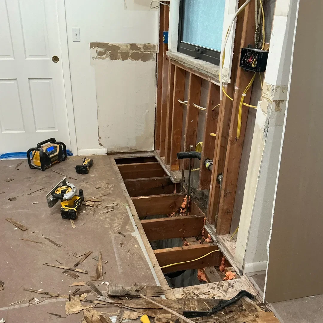 Longmont, CO kitchen remodel in progress, featuring new wall framing, new window trim, and removal of old subfloor,