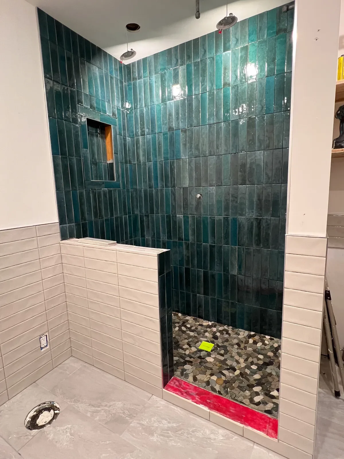 Bathroom under construction in Boulder, CO during remodel featuring nearly completed shower tile