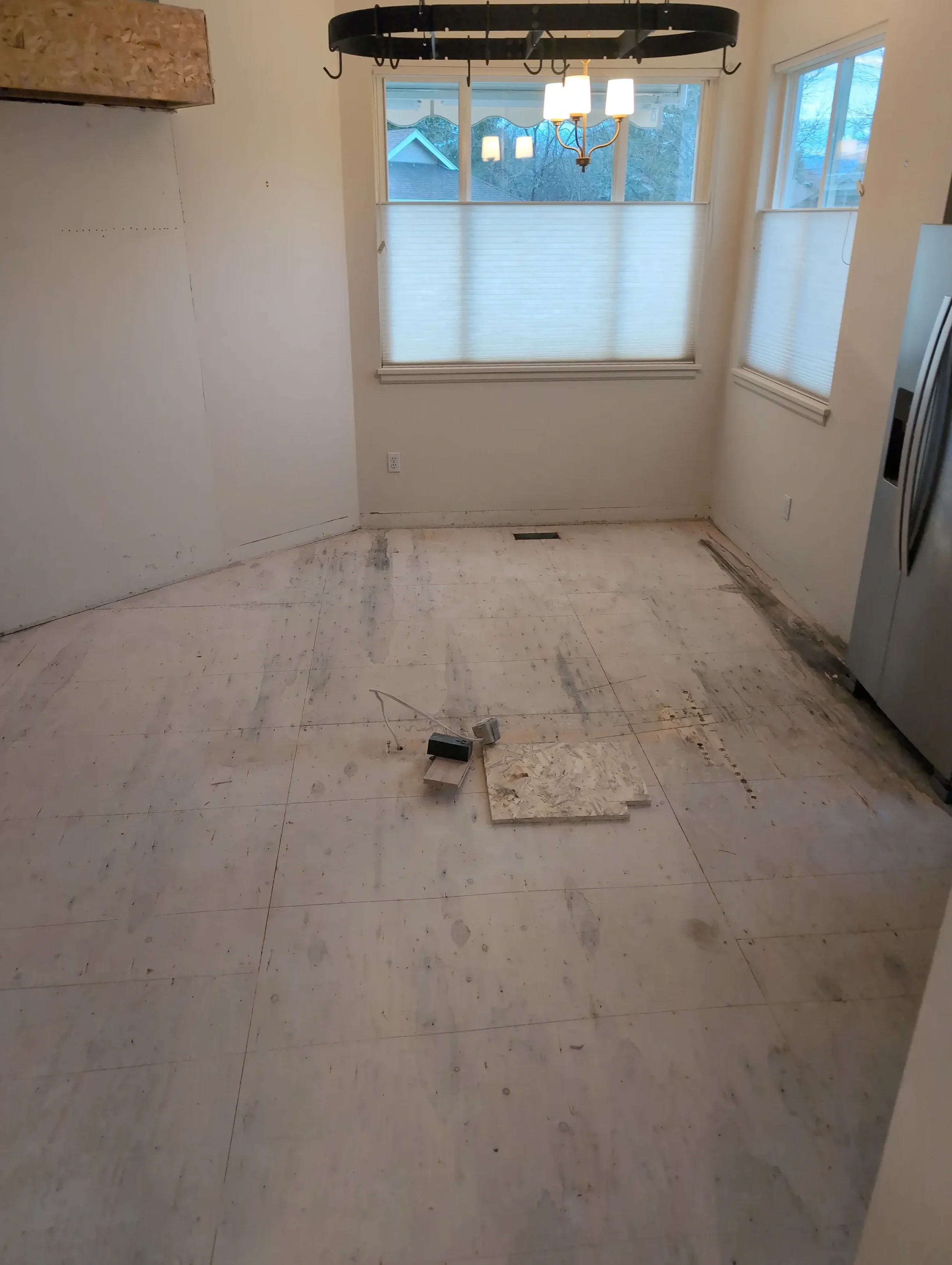 Unfinished kitchen remodel under construction in Gunbarrel, CO featuring completed demolition, floor and cabinet removal. 