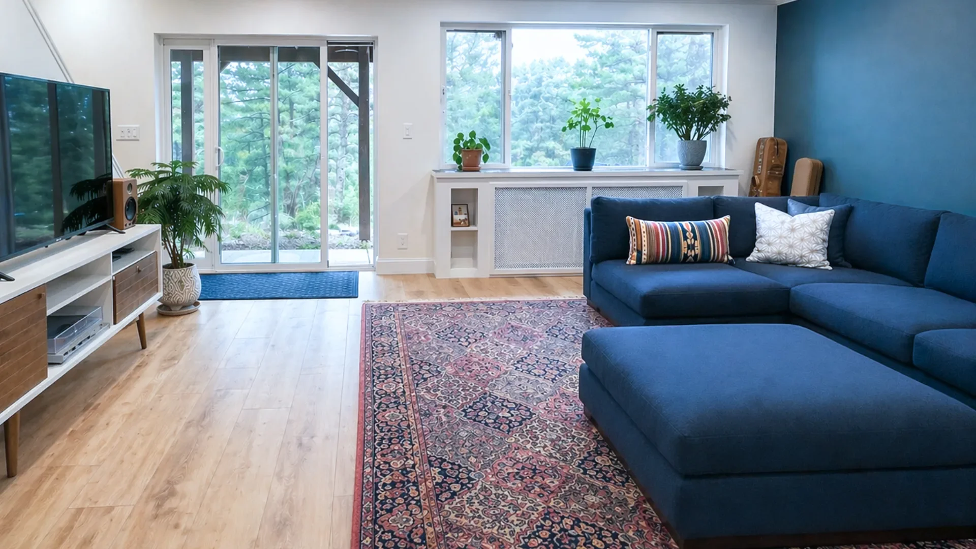 Seven Hills walk-out basement remodel in Boulder, CO featuring family entertainment room with vinyl plank flooring, radiant heat, and herringbone tiled window ledge