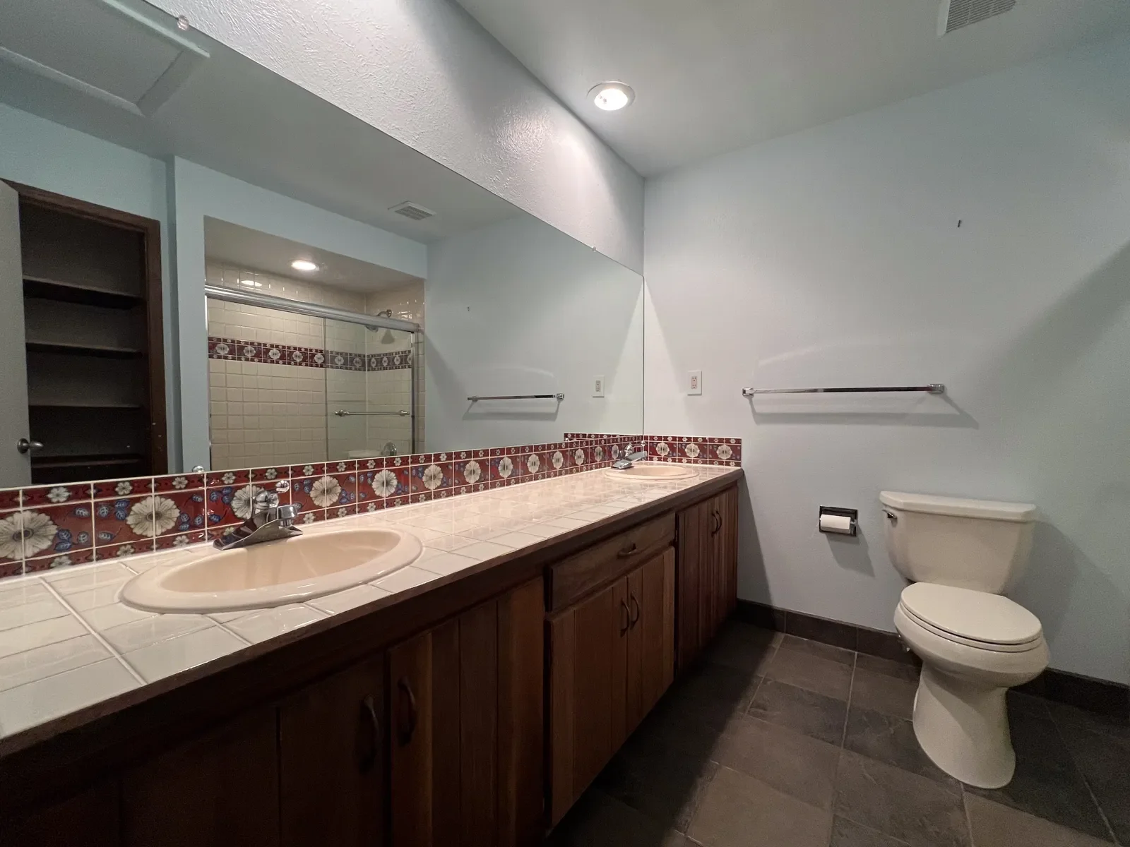 Before photo of bathroom remodel in boulder, co featuring full length tile top wooden vanity and powder blue walls