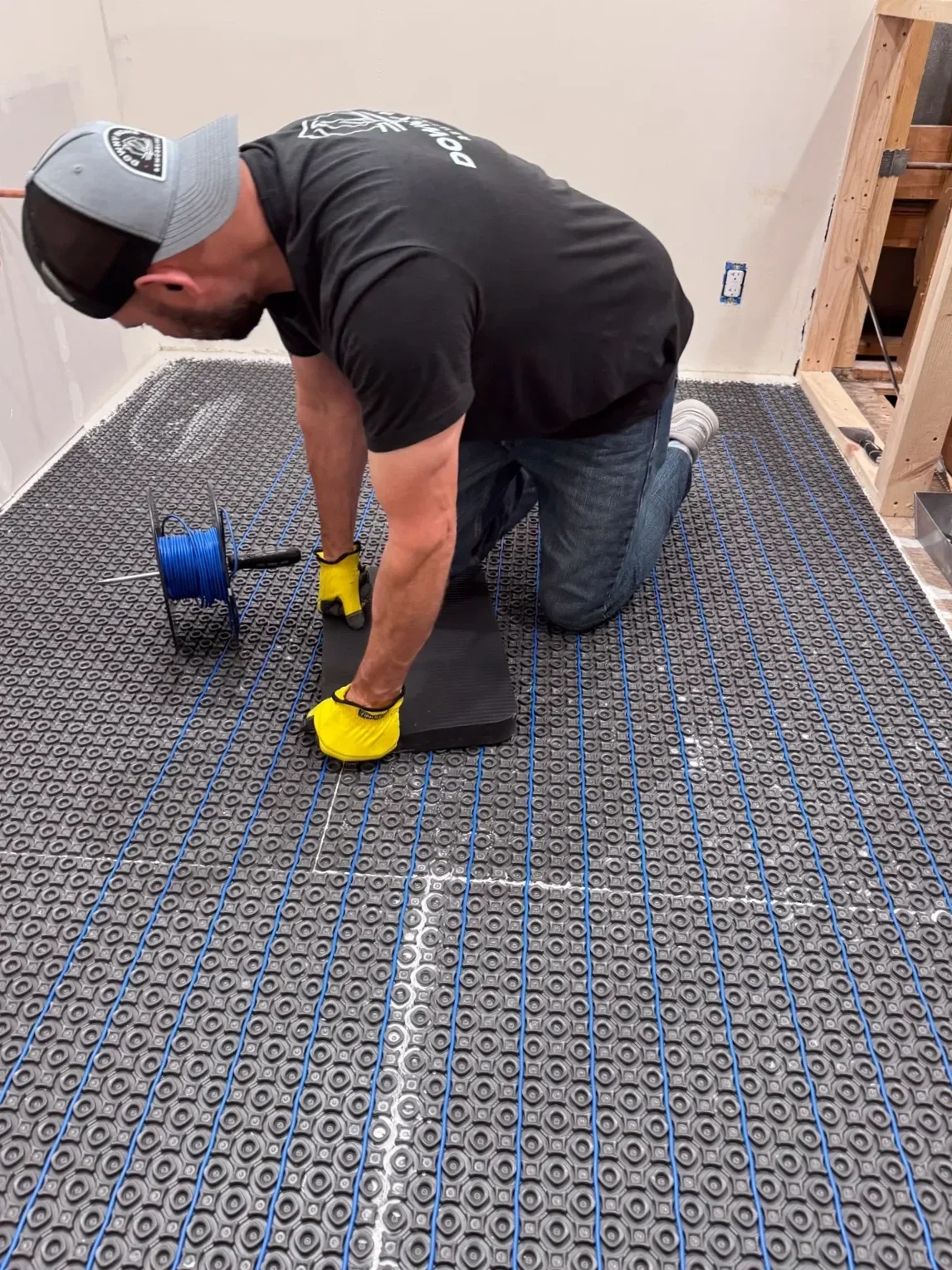 Wayne Mullis owner of Downy Home Remodeling installing heated floor cable in a Boulder, CO bathroom remodel under construction in Chautauqua