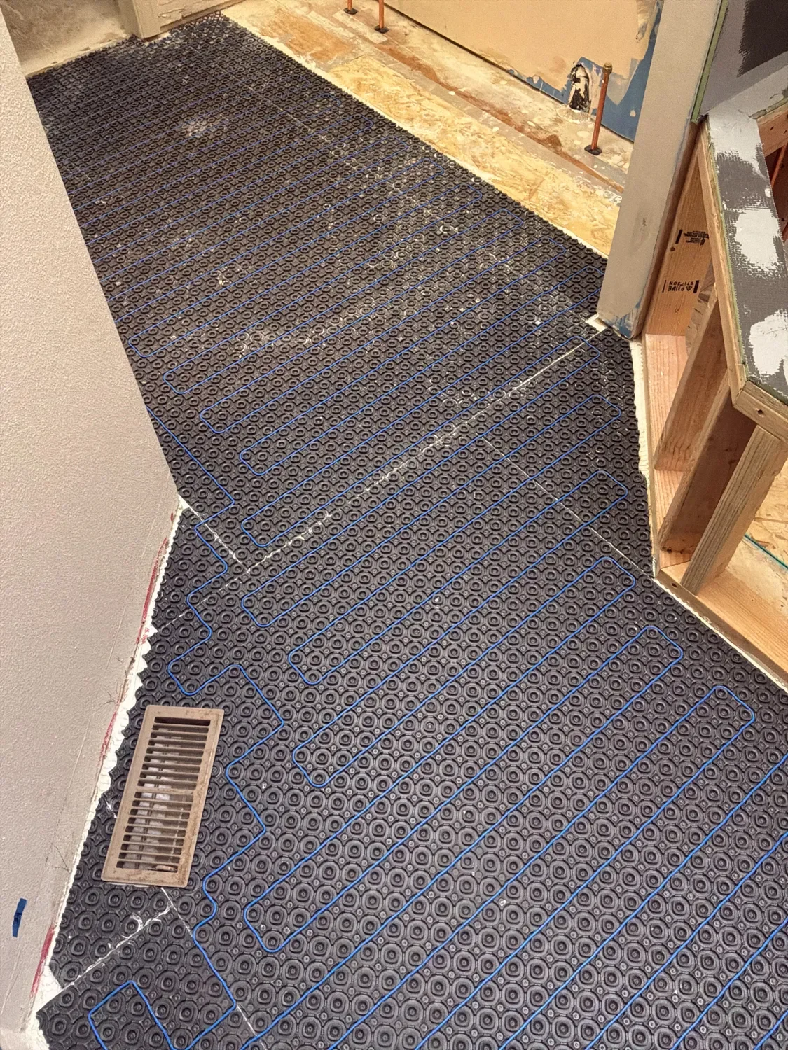 Bathroom subfloor lined with heated cable conduit during construction of a Gunbarrel, CO luxury bathroom upgrade