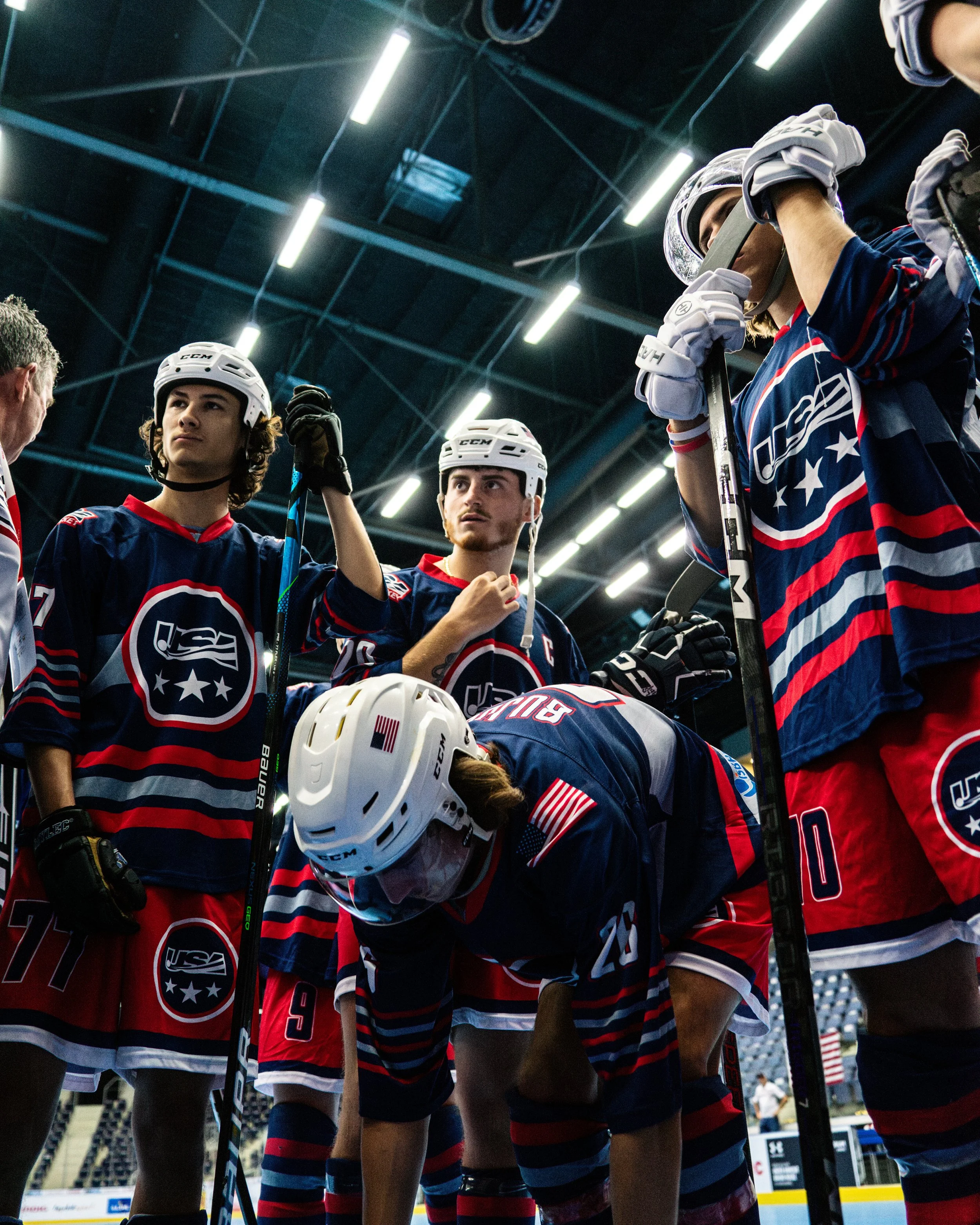 The U23 Men's team huddles around the net after pregame warmups