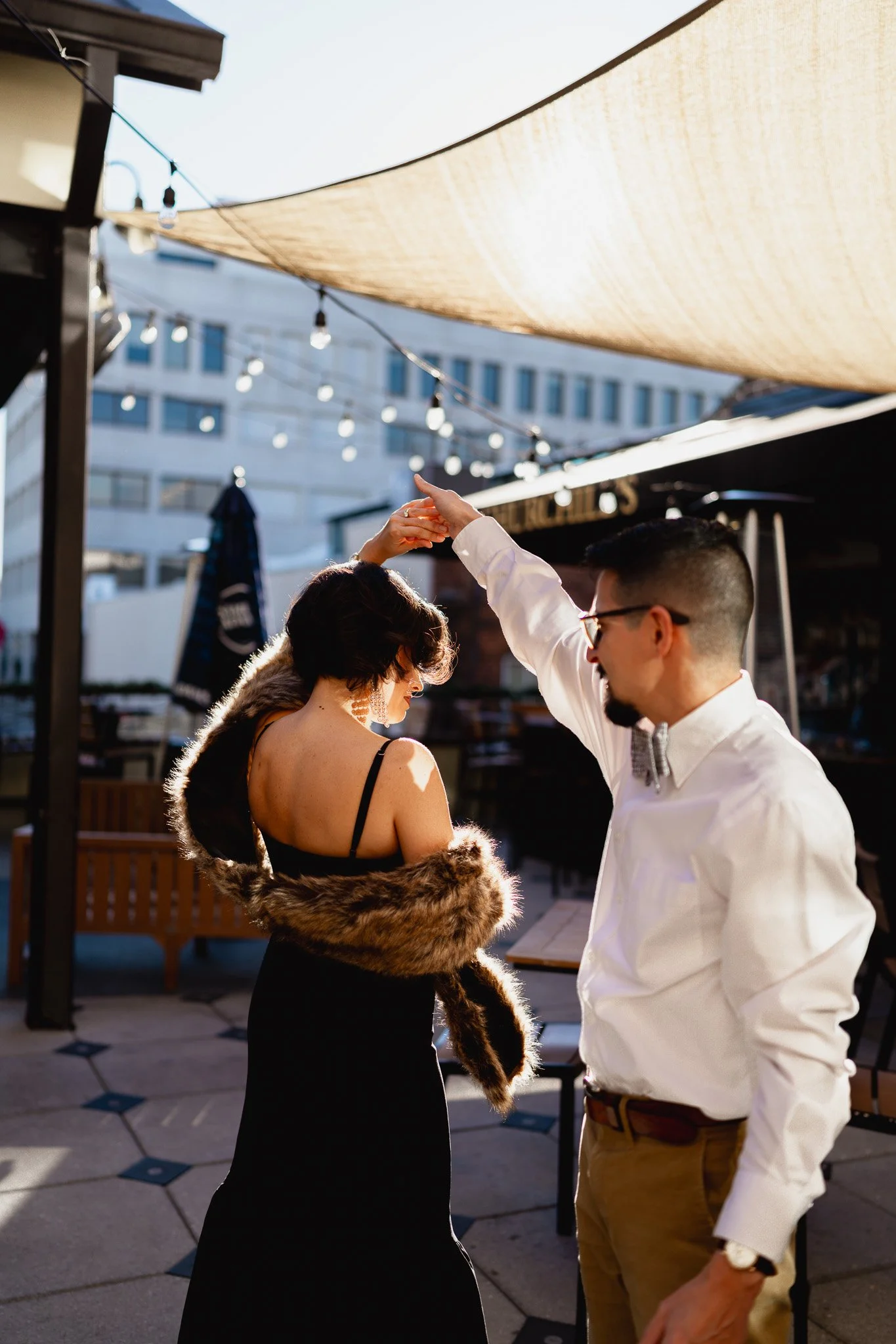 Couple anniversary session on rooftop at Churchill’s on Bay Savannah GA overlooking historic downtown skyline"