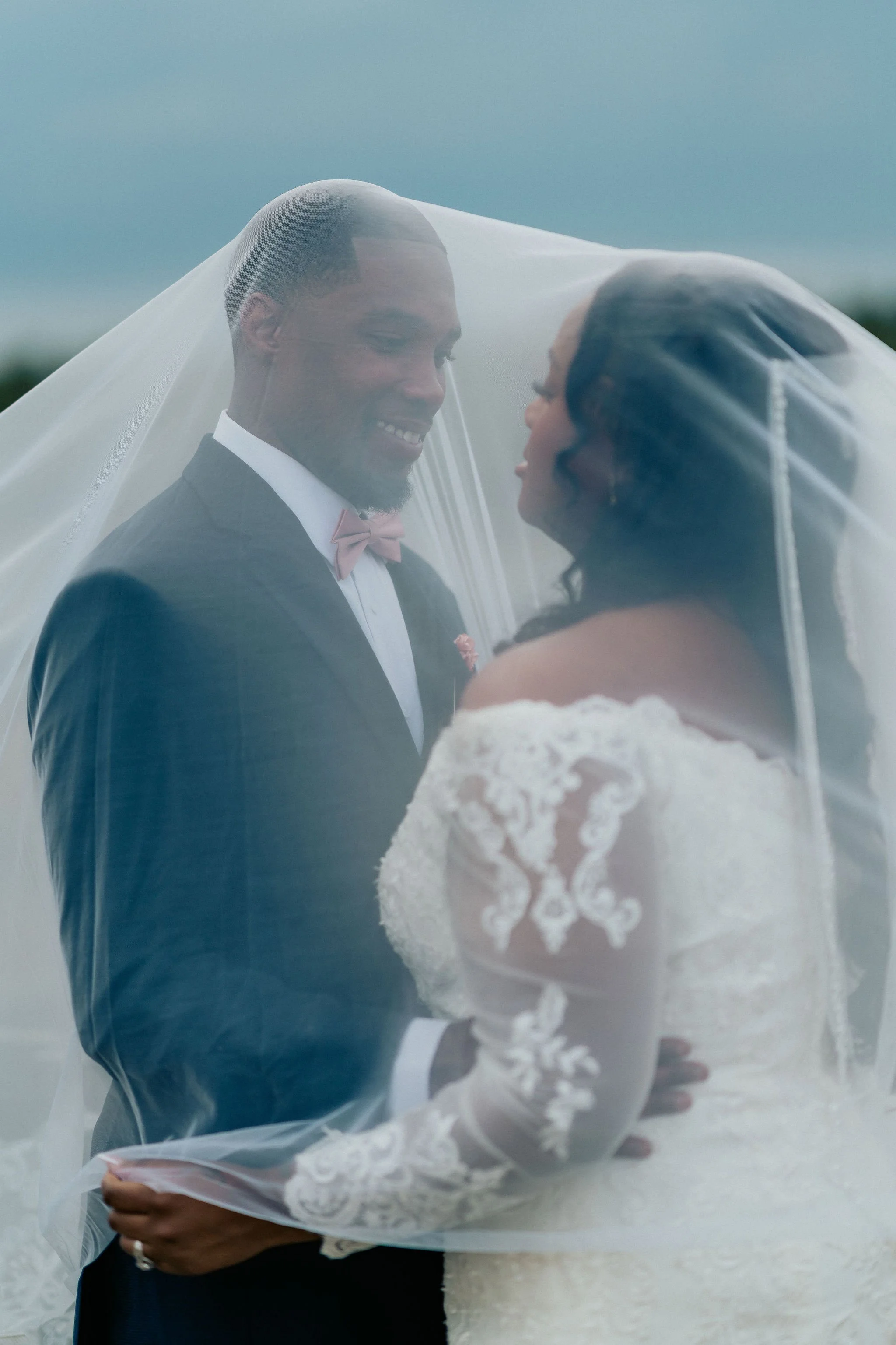 Richmond Hill GA wedding couple black bride and groom under veil getting married with scenic coastal Georgia landscape cinematic wedding photography by ARG Foto