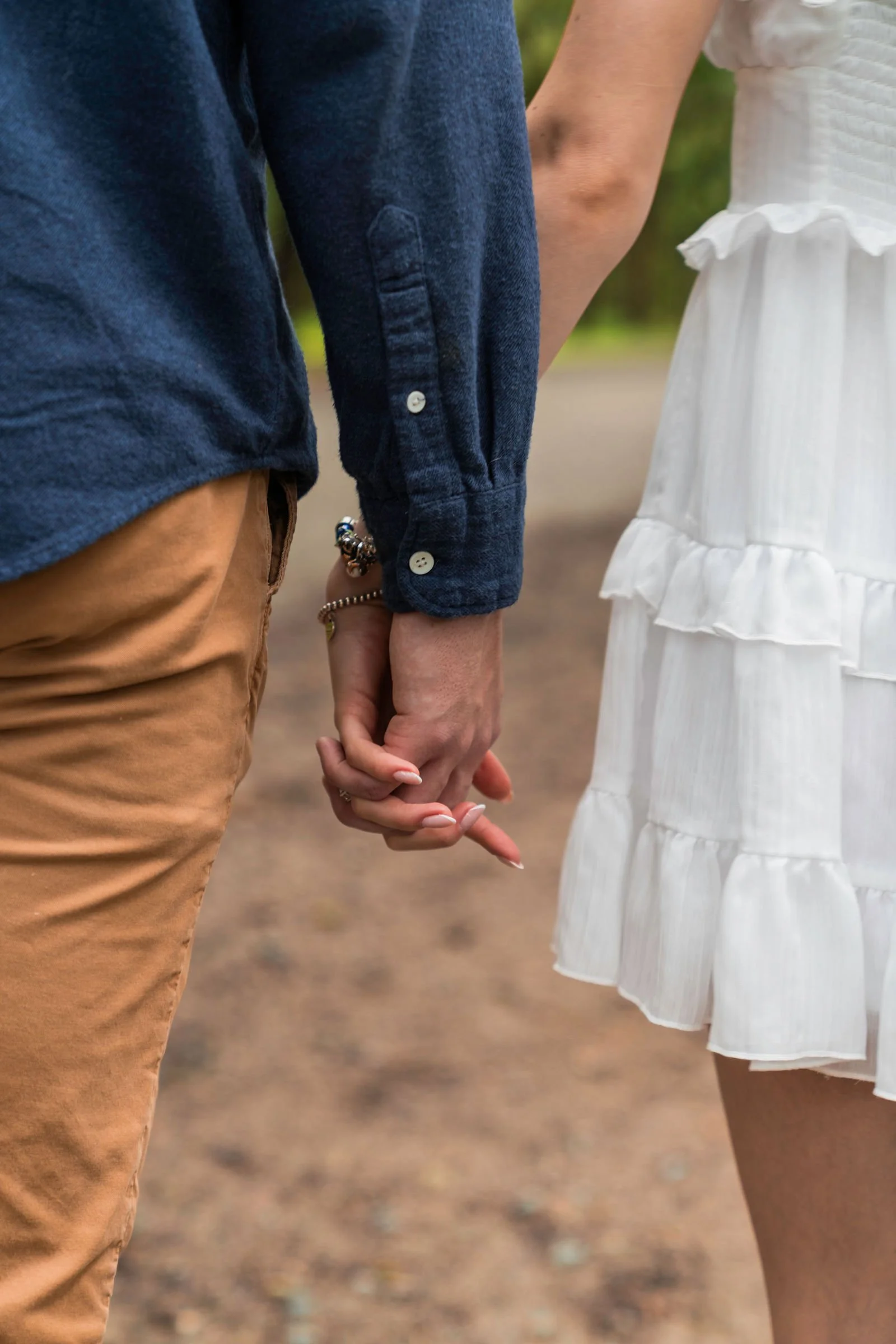 couple getting engaged at wormsloe historic savannah ga holding hands close up shot.jpg