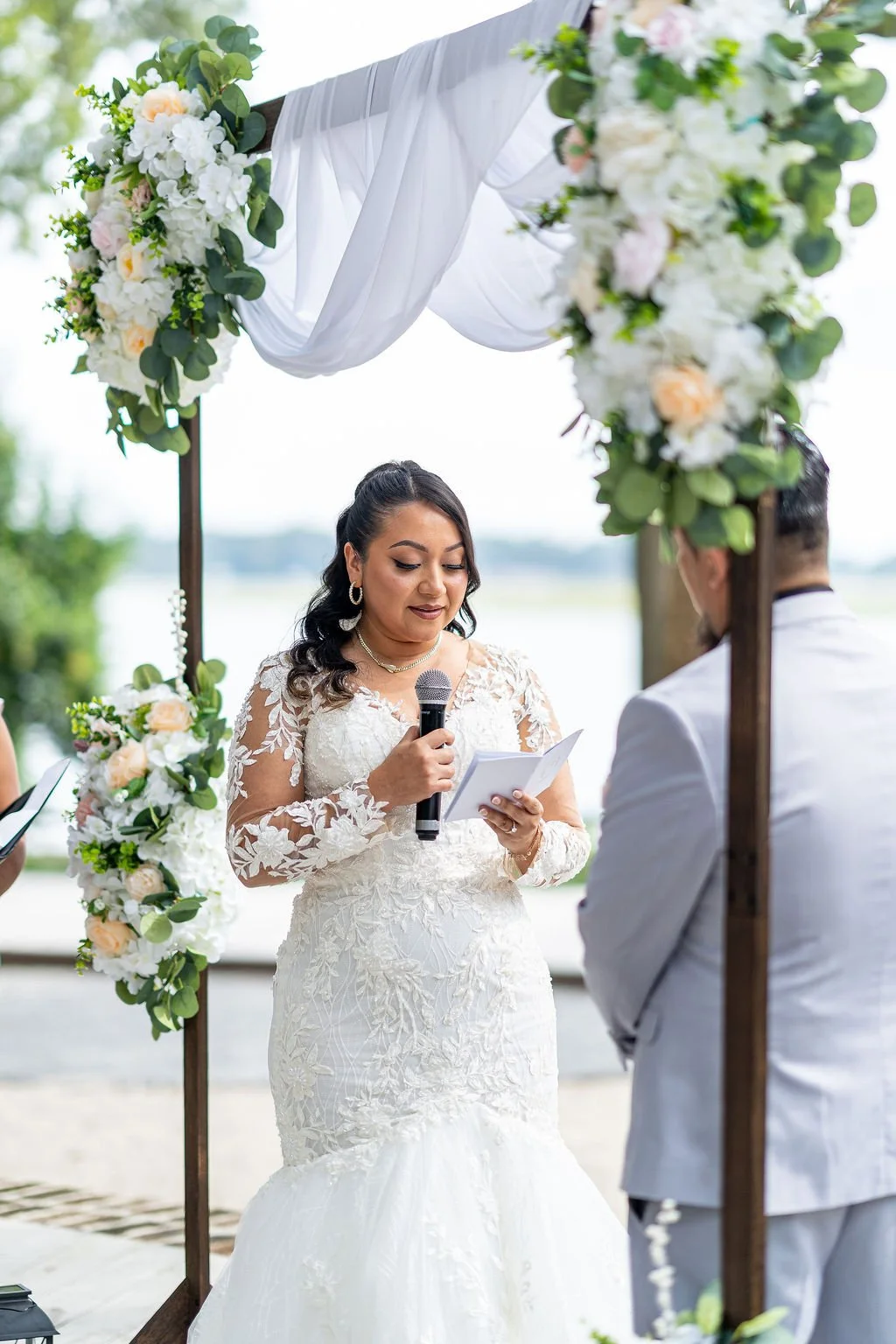 Bluffton SC wedding couple bride and groom exchanging vows and getting married at The Oyster Factory Bluffton cinematic wedding photography by ARG Foto