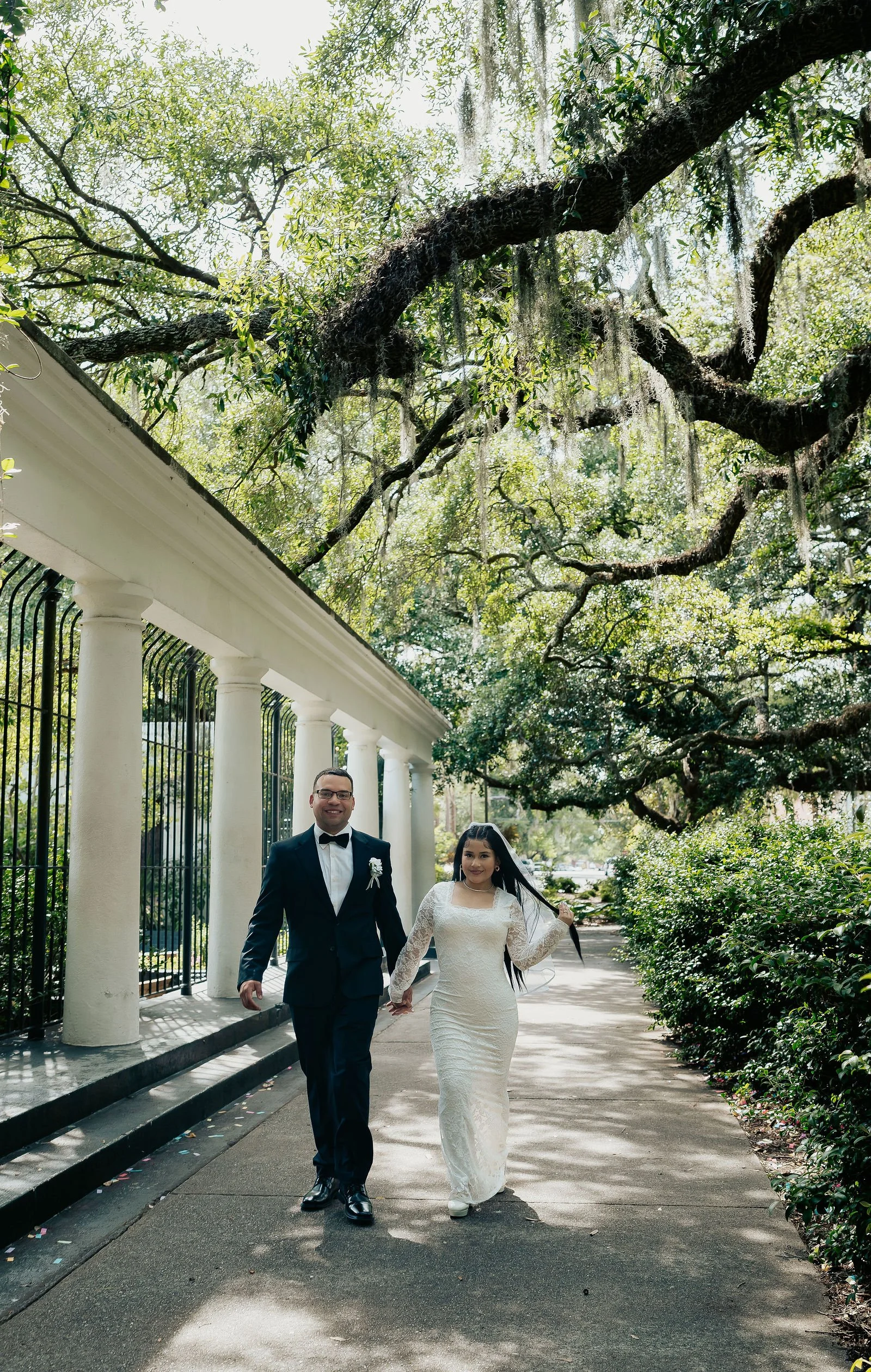 groom and bride garden of fragrance in forsyth park savannah ga walking hand in hand after saying i do wedding and elopement photographer.jpg