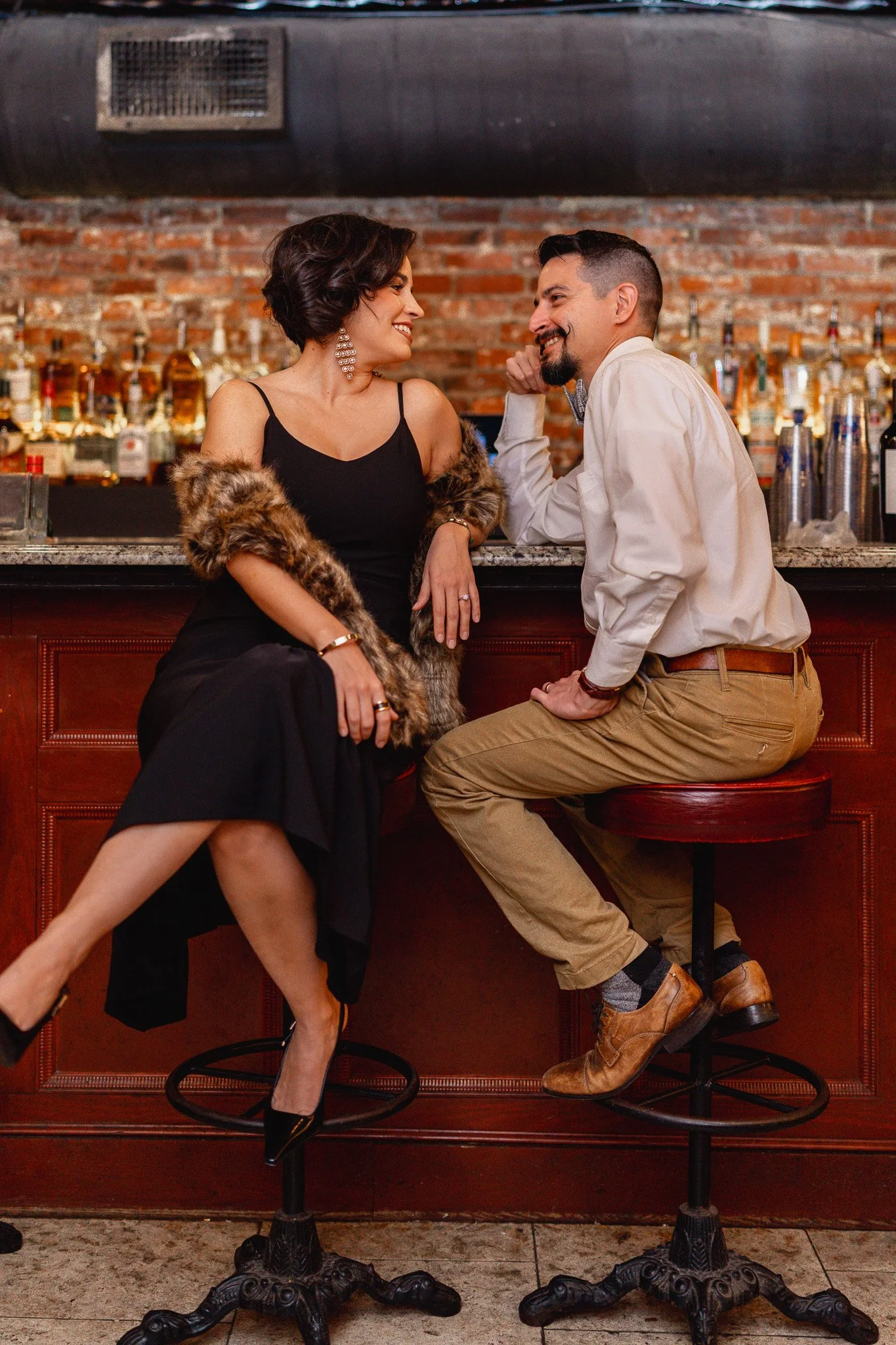 Couple anniversary session on rooftop at Churchill’s on Bay Savannah GA overlooking historic downtown skyline"