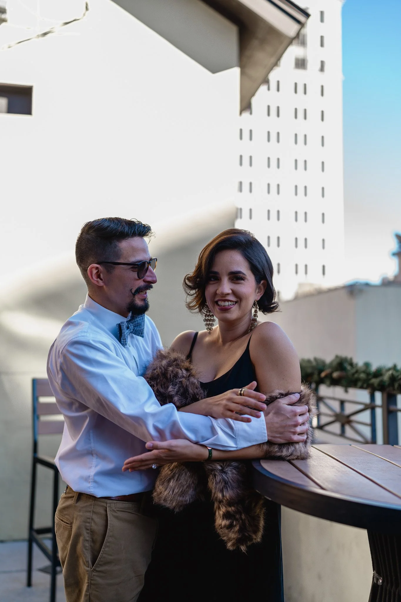 Couple anniversary session on rooftop at Churchill’s on Bay Savannah GA overlooking historic downtown skyline"