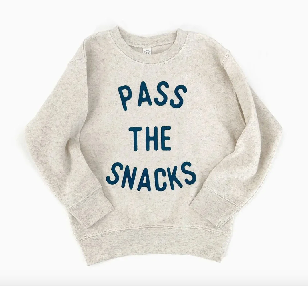 Snack time, but make it fashion 🧃🧸 For the littles who are always asking what&rsquo;s next on the menu, this cozy sweatshirt says it all.
⠀
🍿 Natural color with vibrant lettering
👕 Soft, comfy fit for playdates, snack breaks, and everything in be