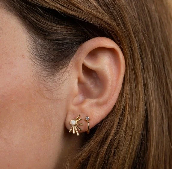 A little shimmer, a lot of sunshine ☀️ This delicate white opal stud is set inside an organically shaped sun ray &mdash; designed to catch the light just right.
⠀
✨ Lab-grown white opal
🌞 18K gold-plated brass with sterling silver posts
💧 Tarnish-f