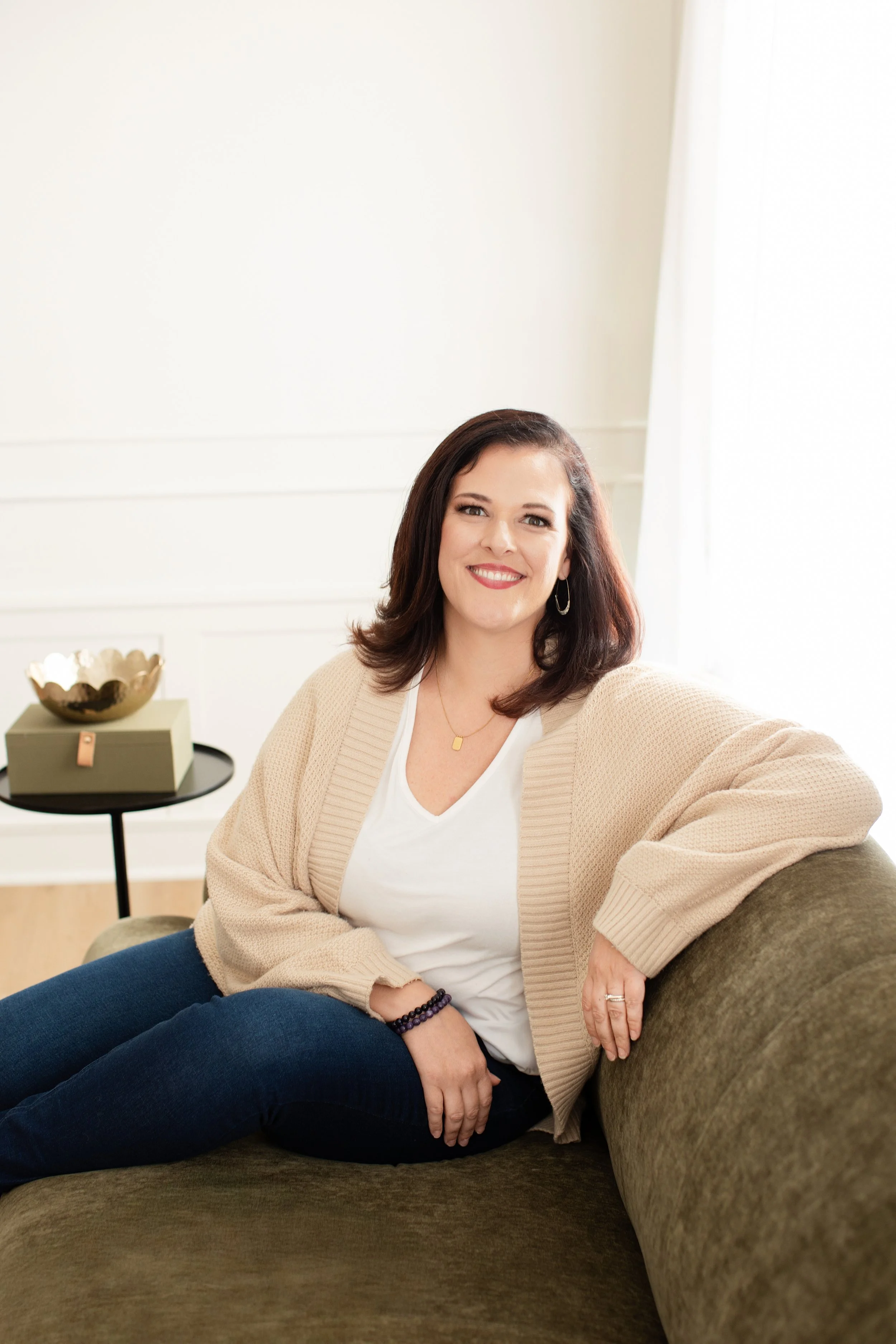 emma mulvany, empowerment mentor, smiling on couch, relaxed