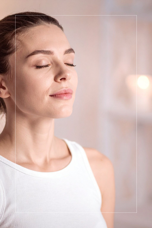 woman meditating, eyes closed, peaceful