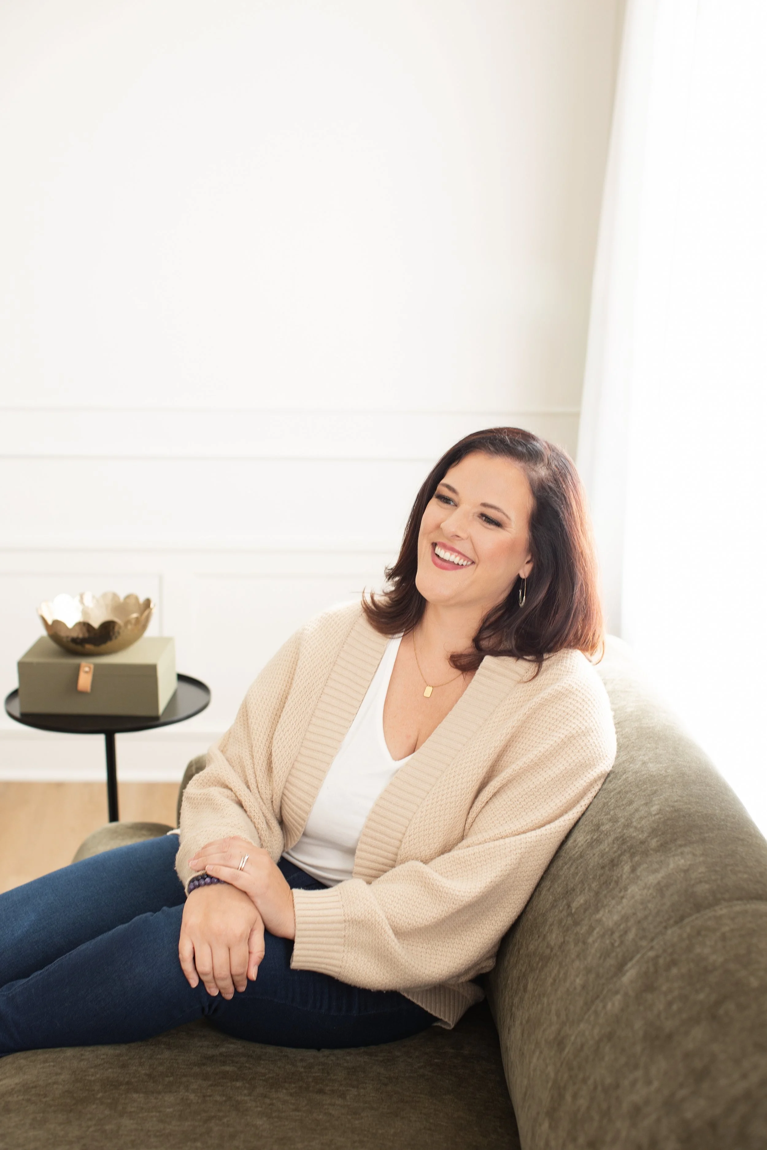 emma mulvany, empowerment mentor, smiling, relaxed on couch