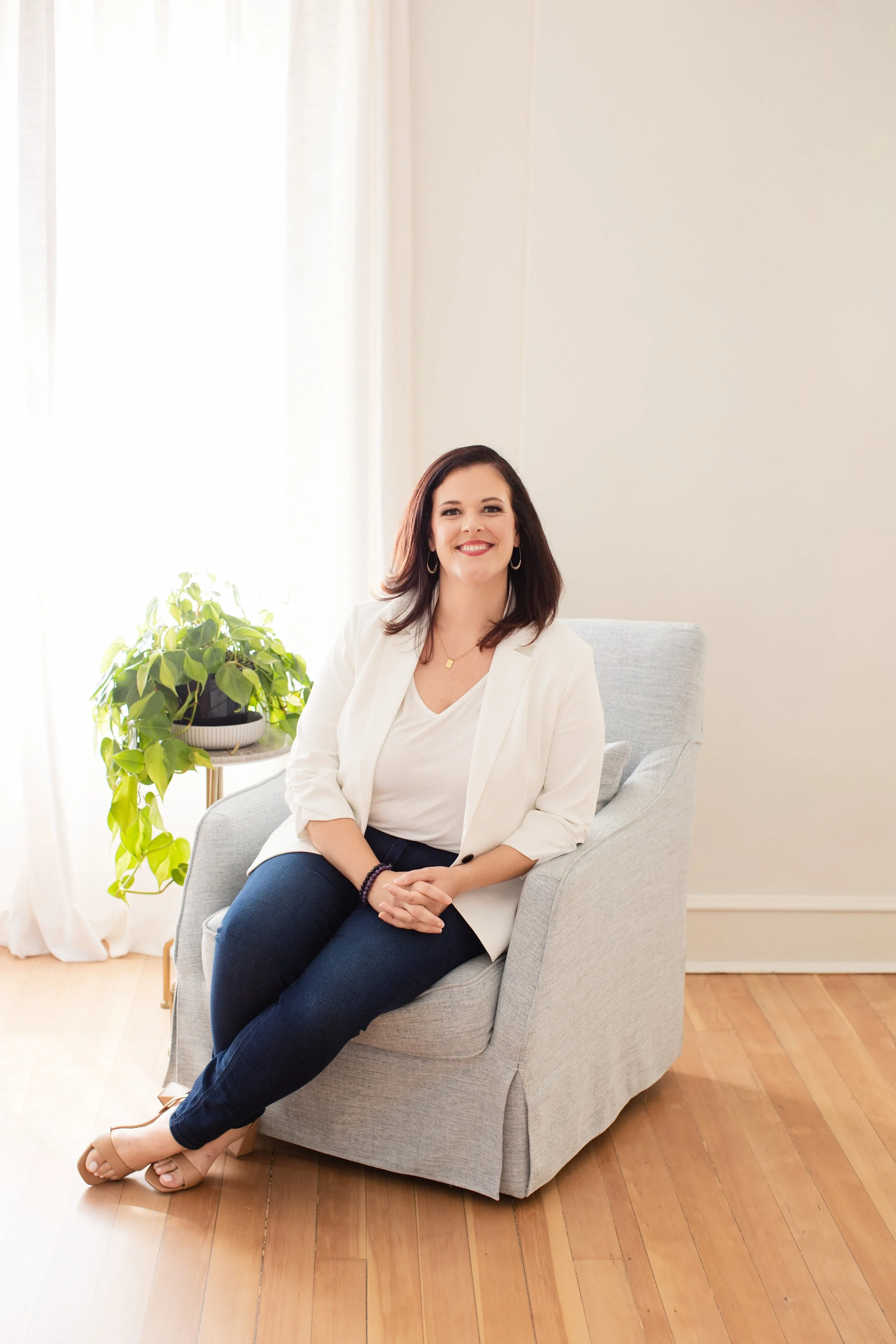 emma mulvany, womens empowerment mentor, smiling on chair