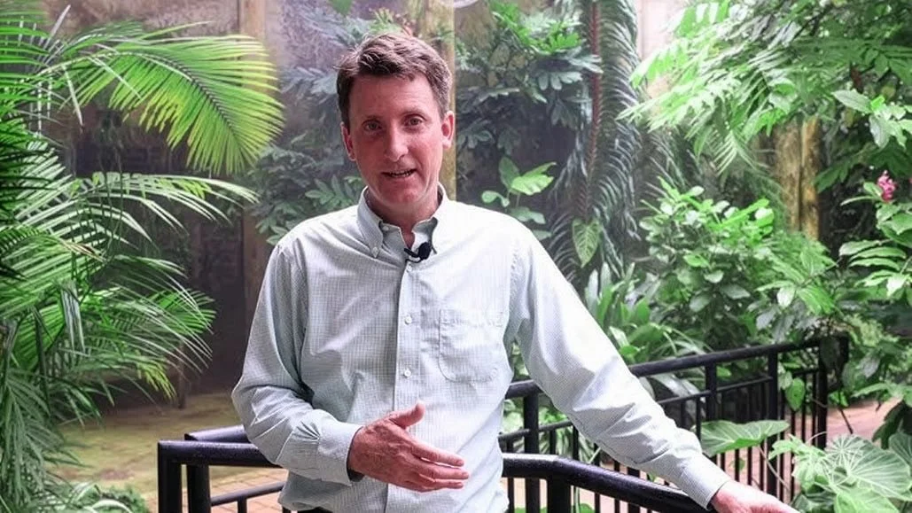 Director of Fairchild Tropical Botanic Garden, Dr. Carl Lewis stands in the tropical plant conservatory