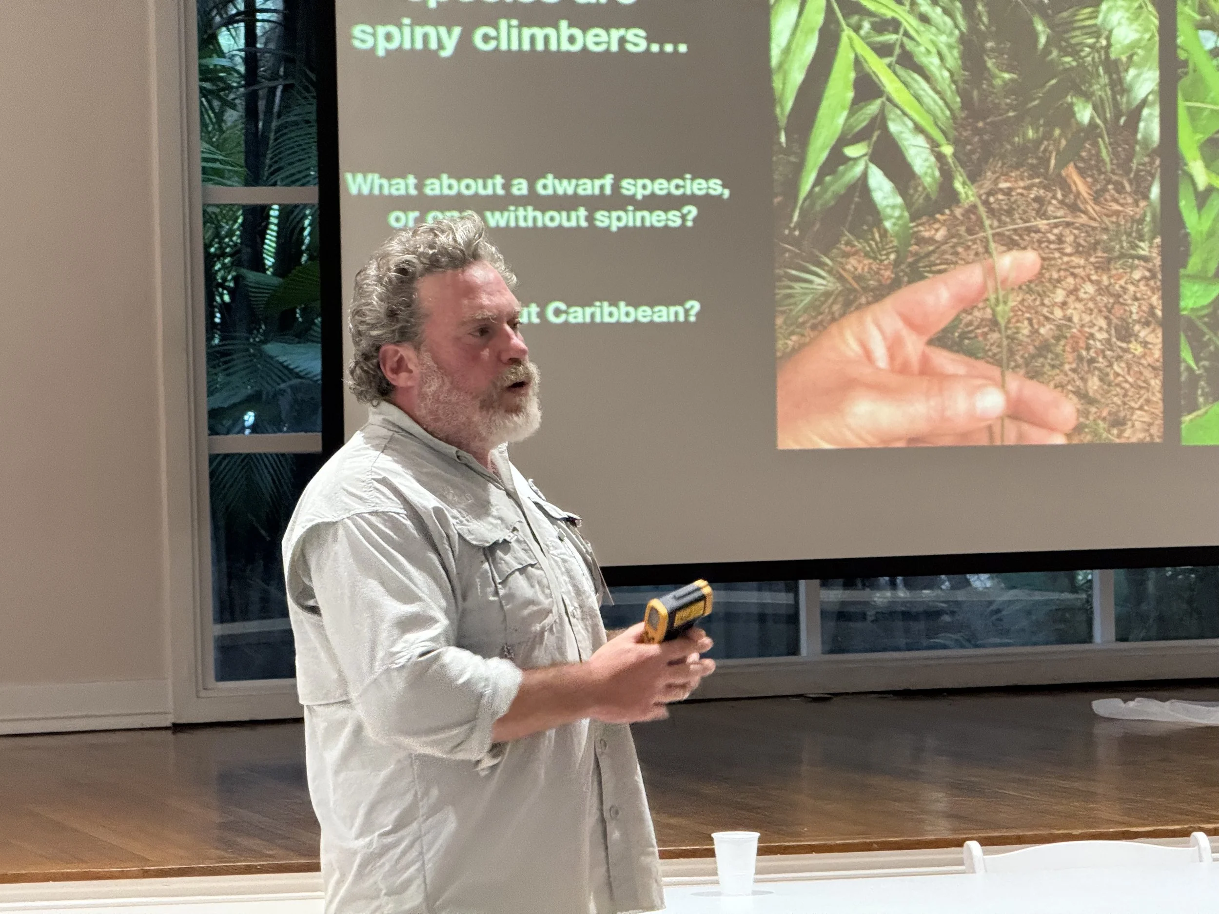 Brett Jestrow presenting in front of a slide with palms