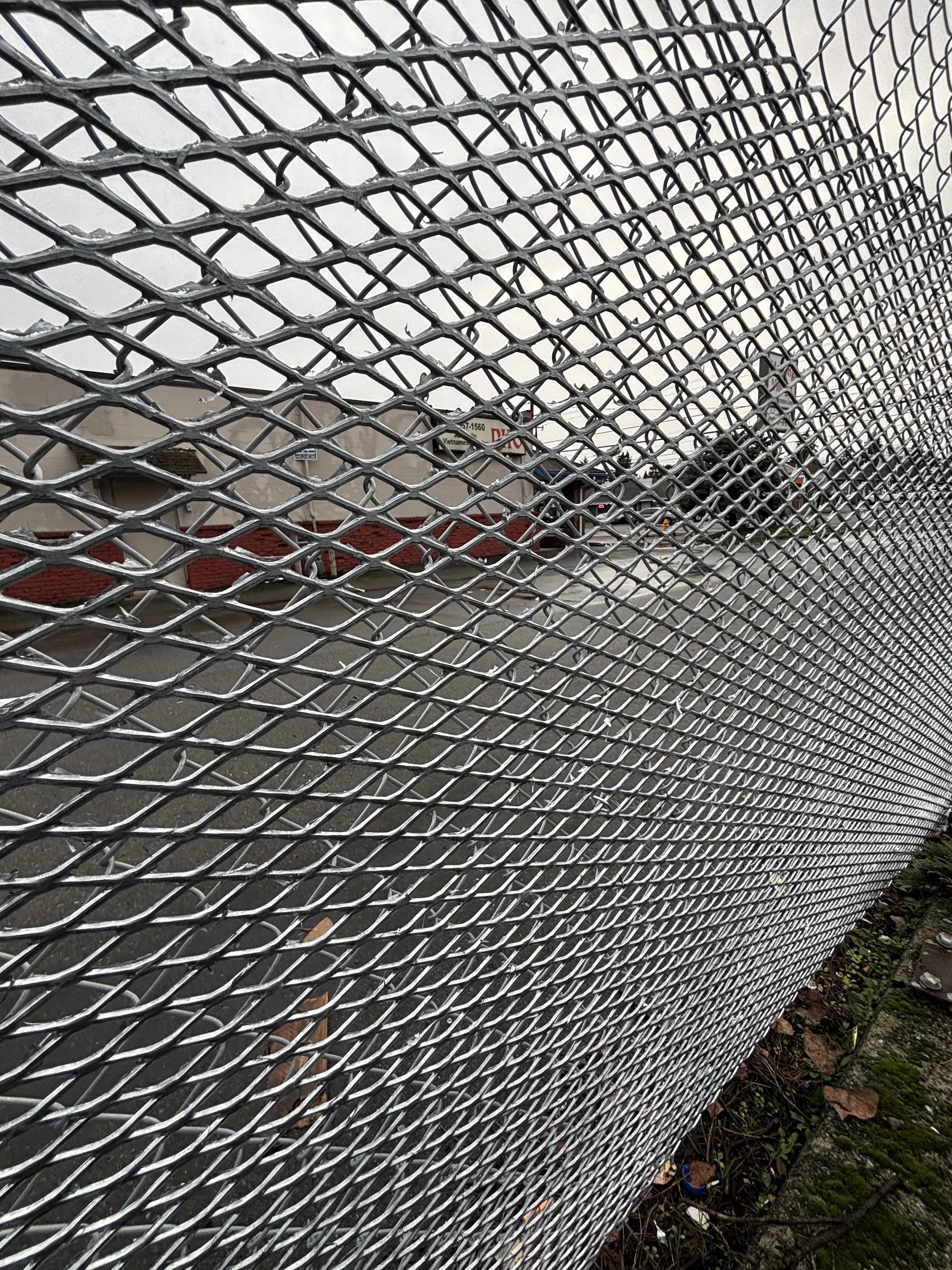 Expanded metal added to chain link fence to help keep trespassers off of property