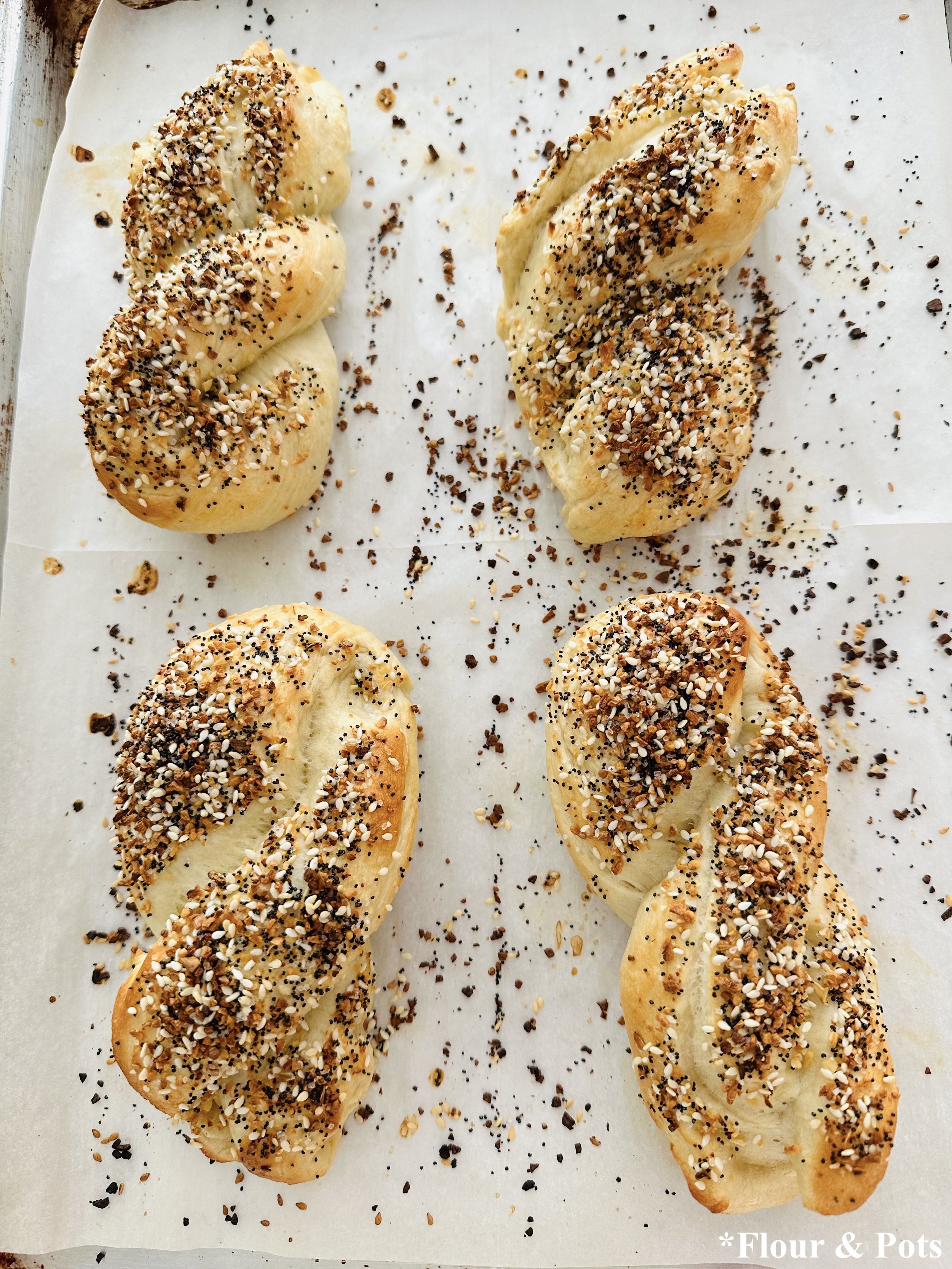 Fresh baked honey bagels shaped into twists and sprinkled with seasoning