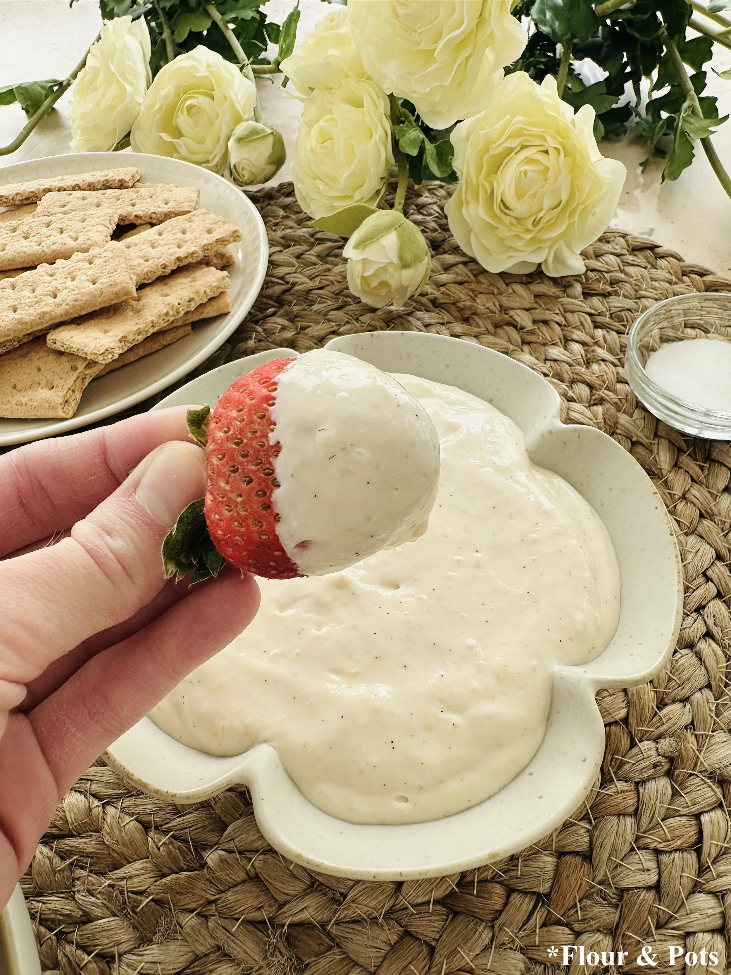 Creamy lemon cheesecake fruit dip in a bowl with fresh berries