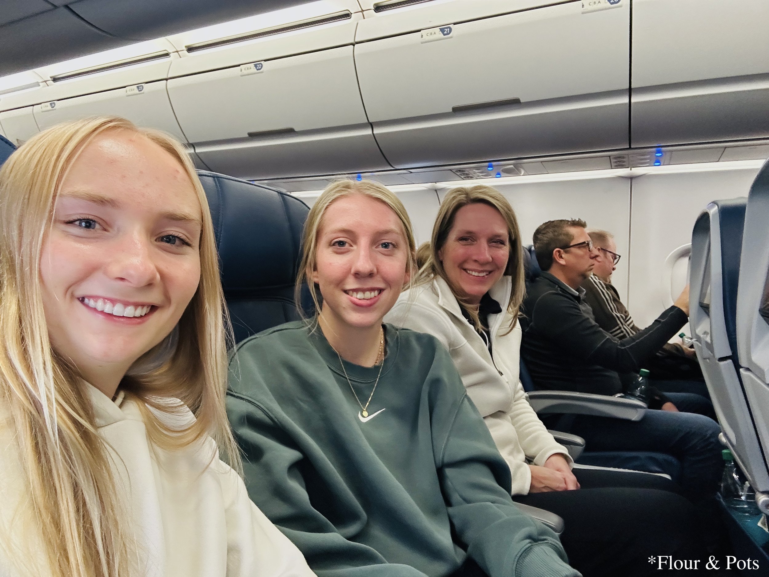 A family selfie taken before takeoff, smiling together in our airplane seats. The photo captures the excitement and tradition of our annual spring trip.