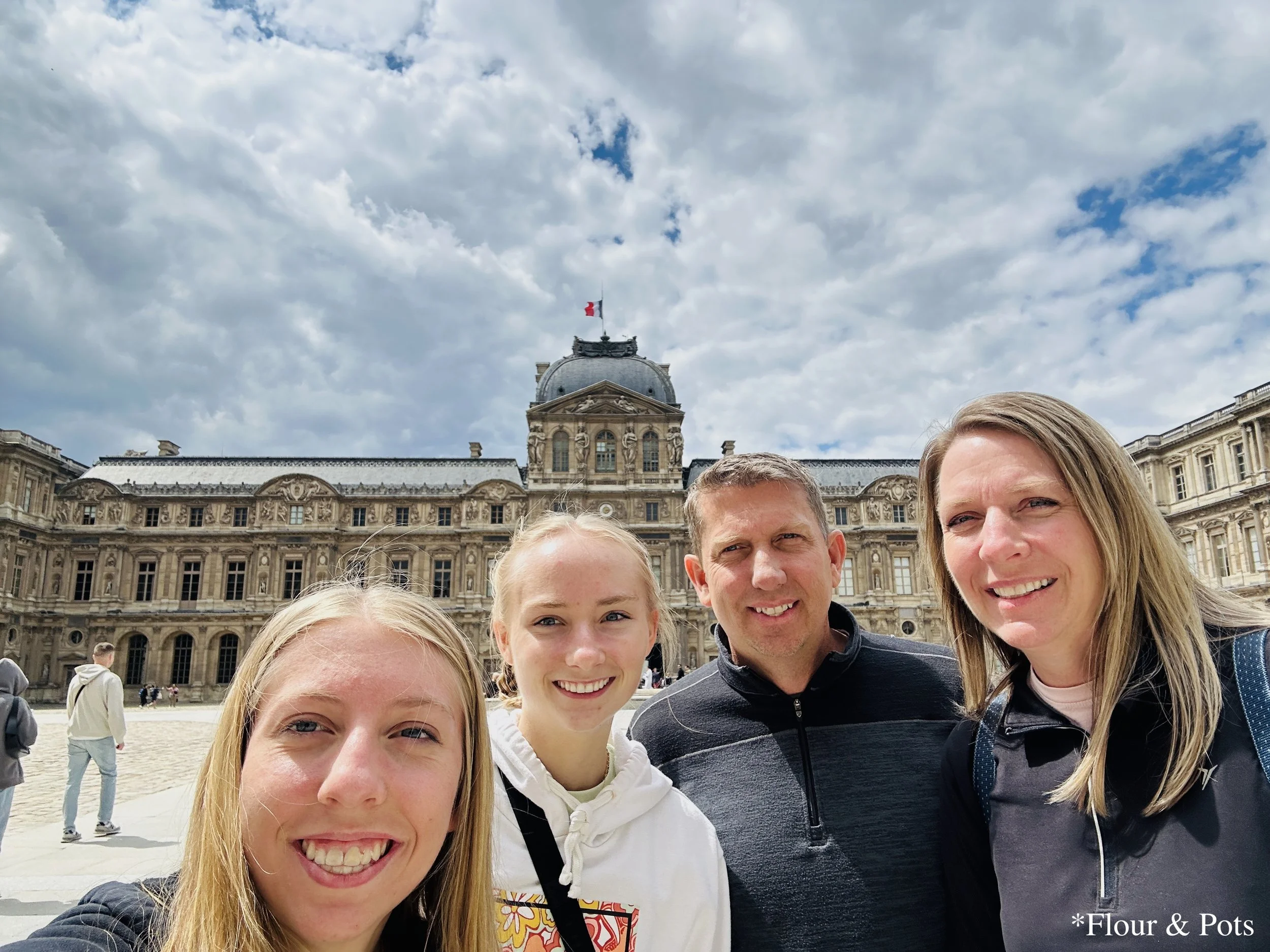 My family standing in front of the Louvre Palace in Paris, France.