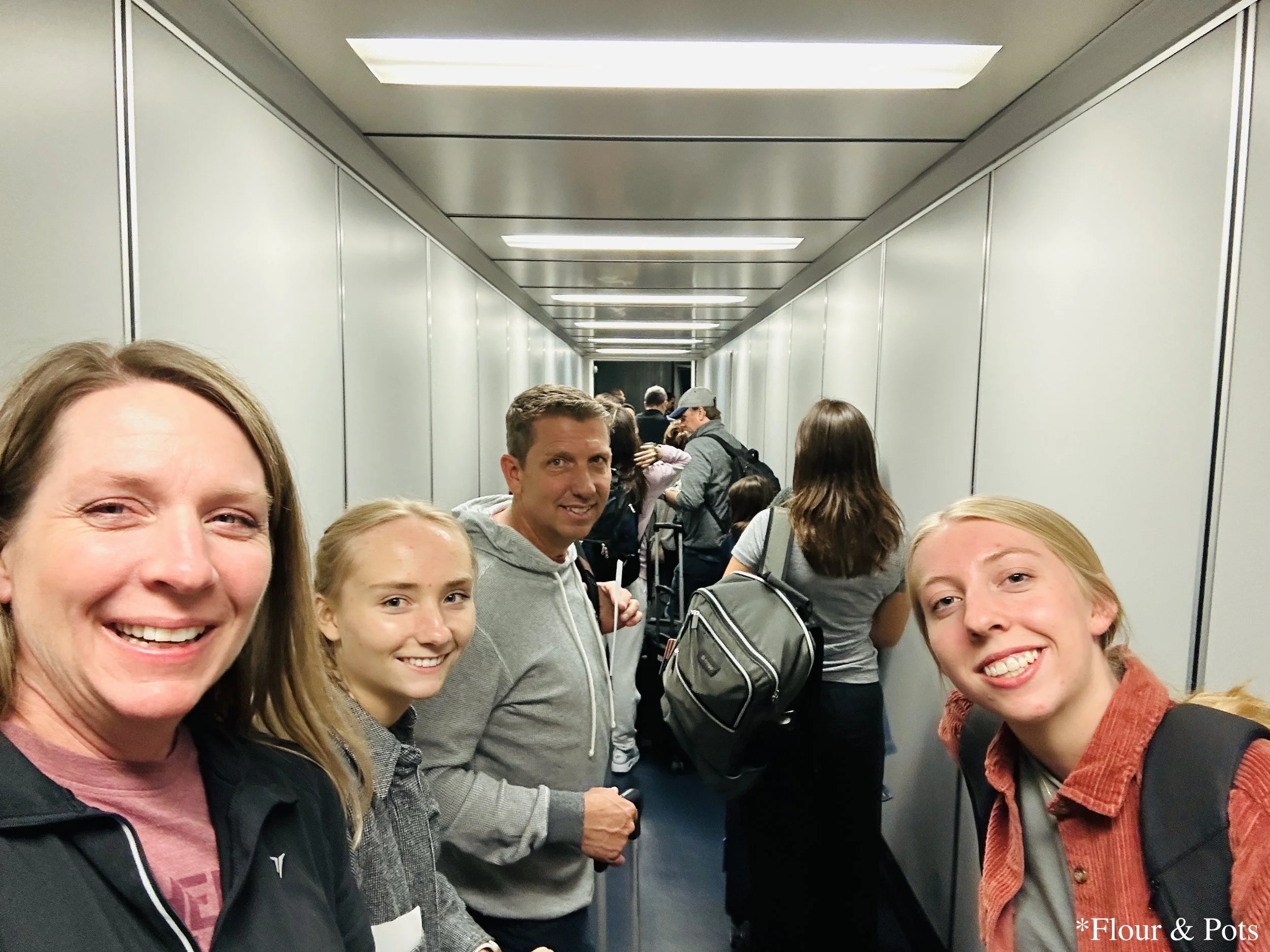 A family walking up the jet bridge to board an Iberia Airlines plane bound for Madrid from Dallas/Fort Worth Airport.