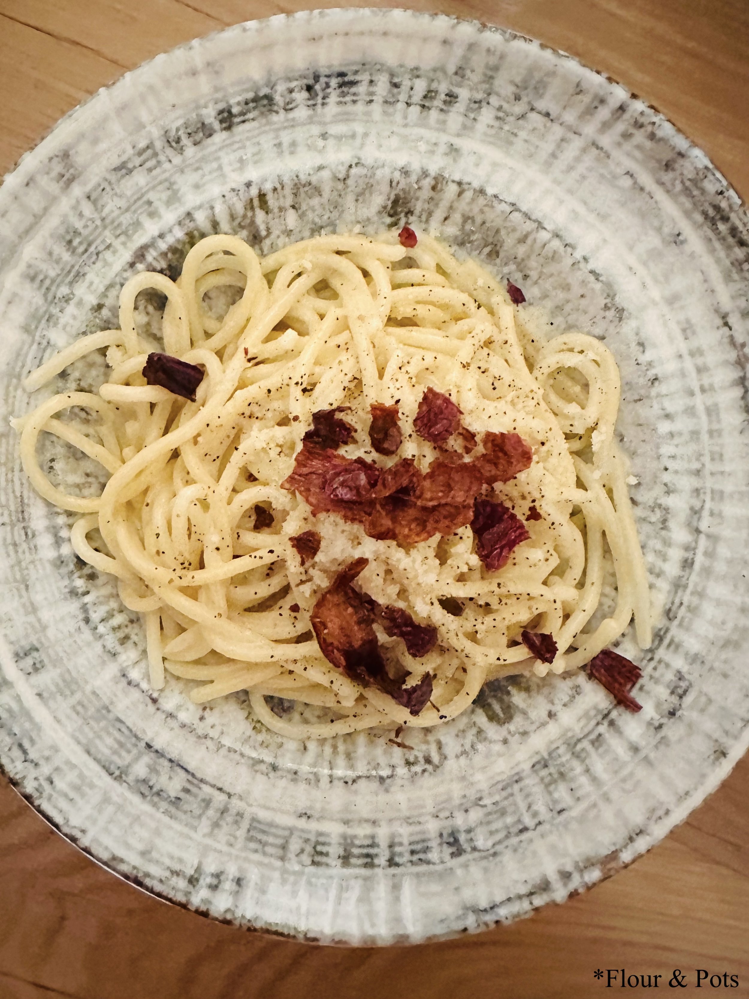 Mouth-watering Cacio e Pepe pasta topped with creamy, peppery cheese sauce from Obicá in Rome, Italy.