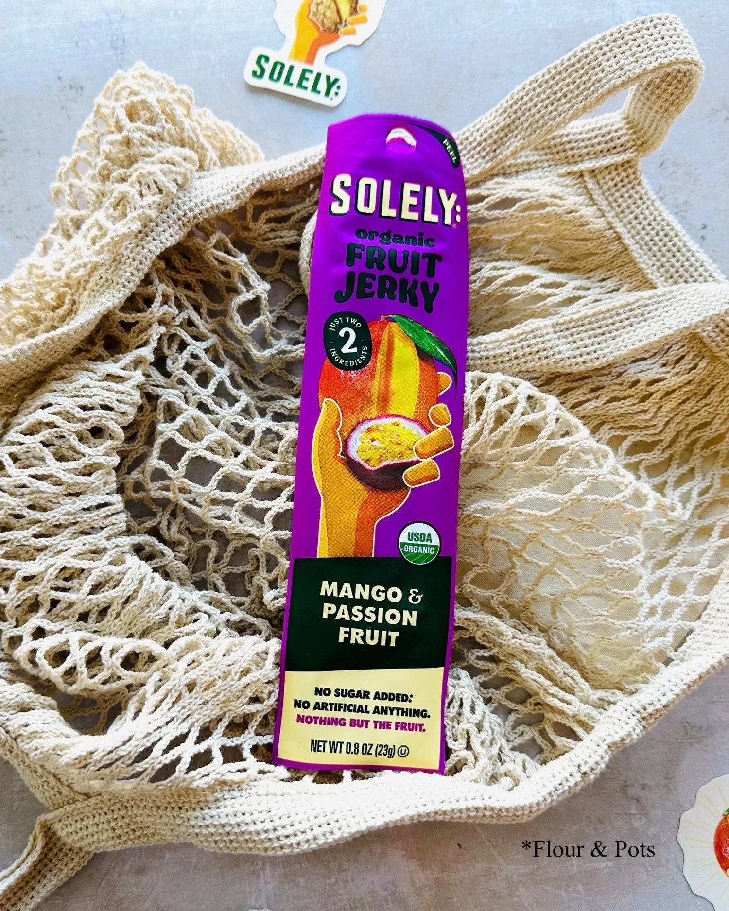 Solely Organic Mango & Passion Fruit fruit jerky stick package with a vibrant tropical fruit design.