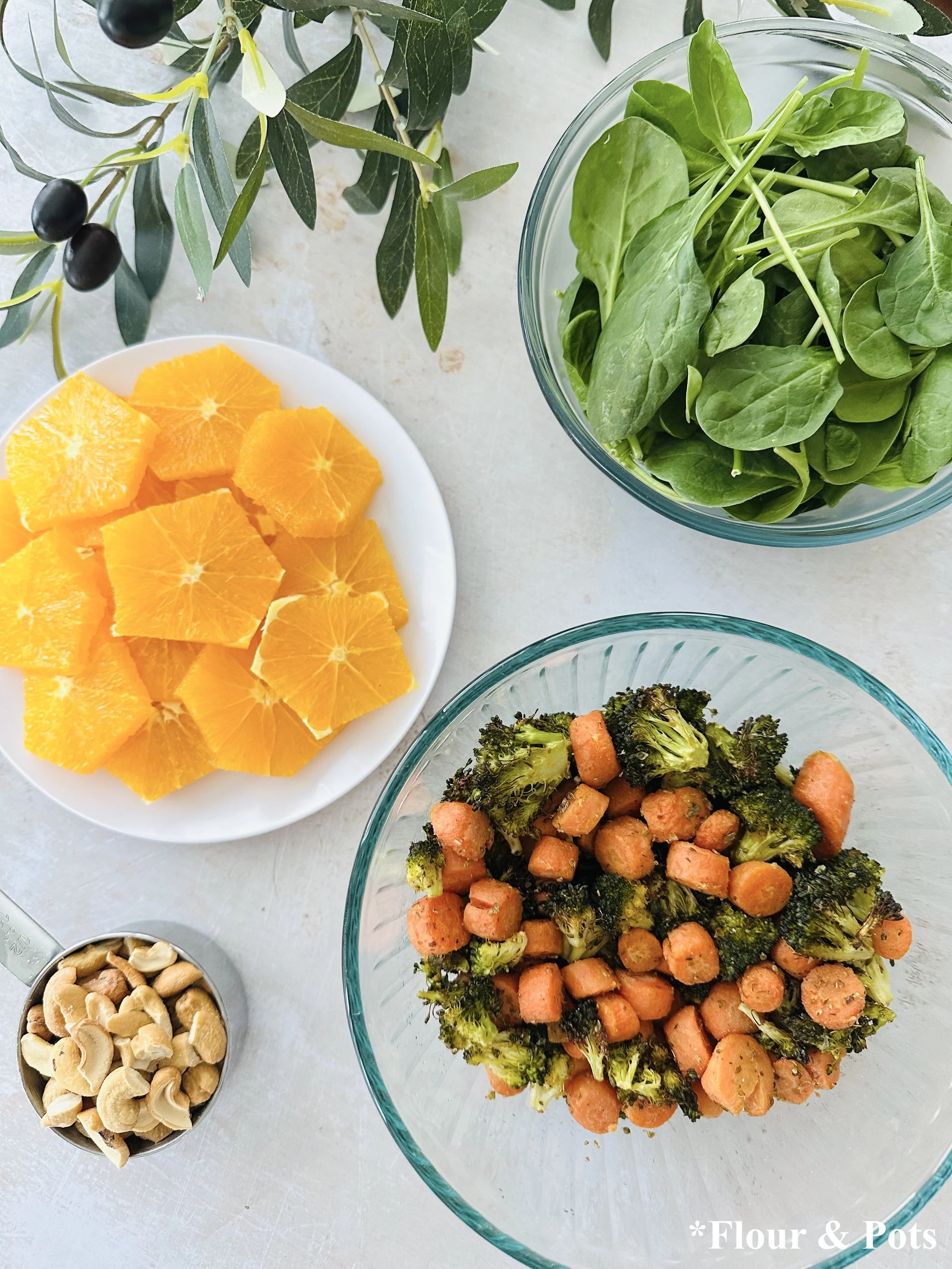 Mediterranean-style spinach salad with roasted veggies and olive oil dressing Toppings