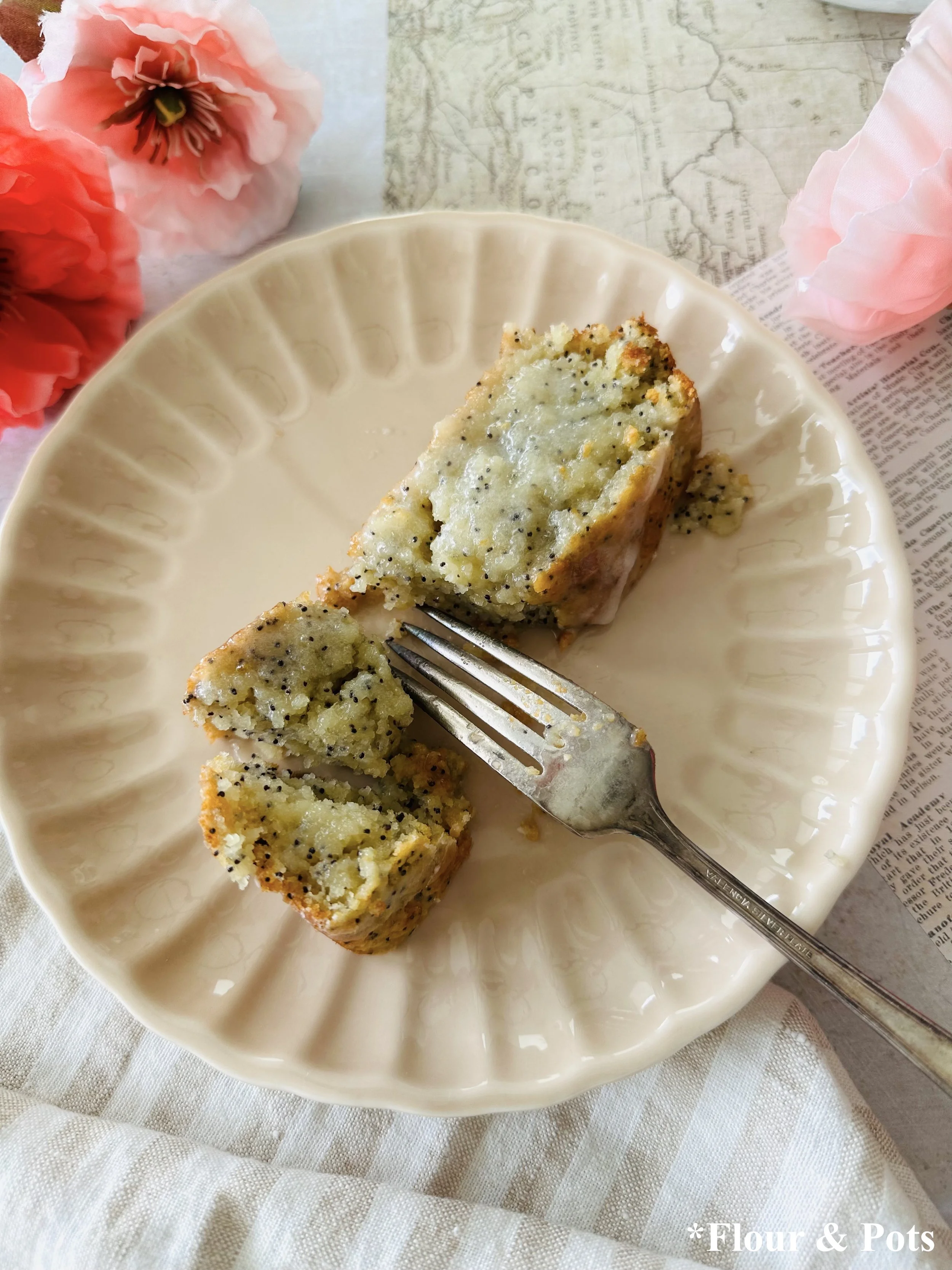 Thick slice of almond poppy seed bread with hardened glaze on top