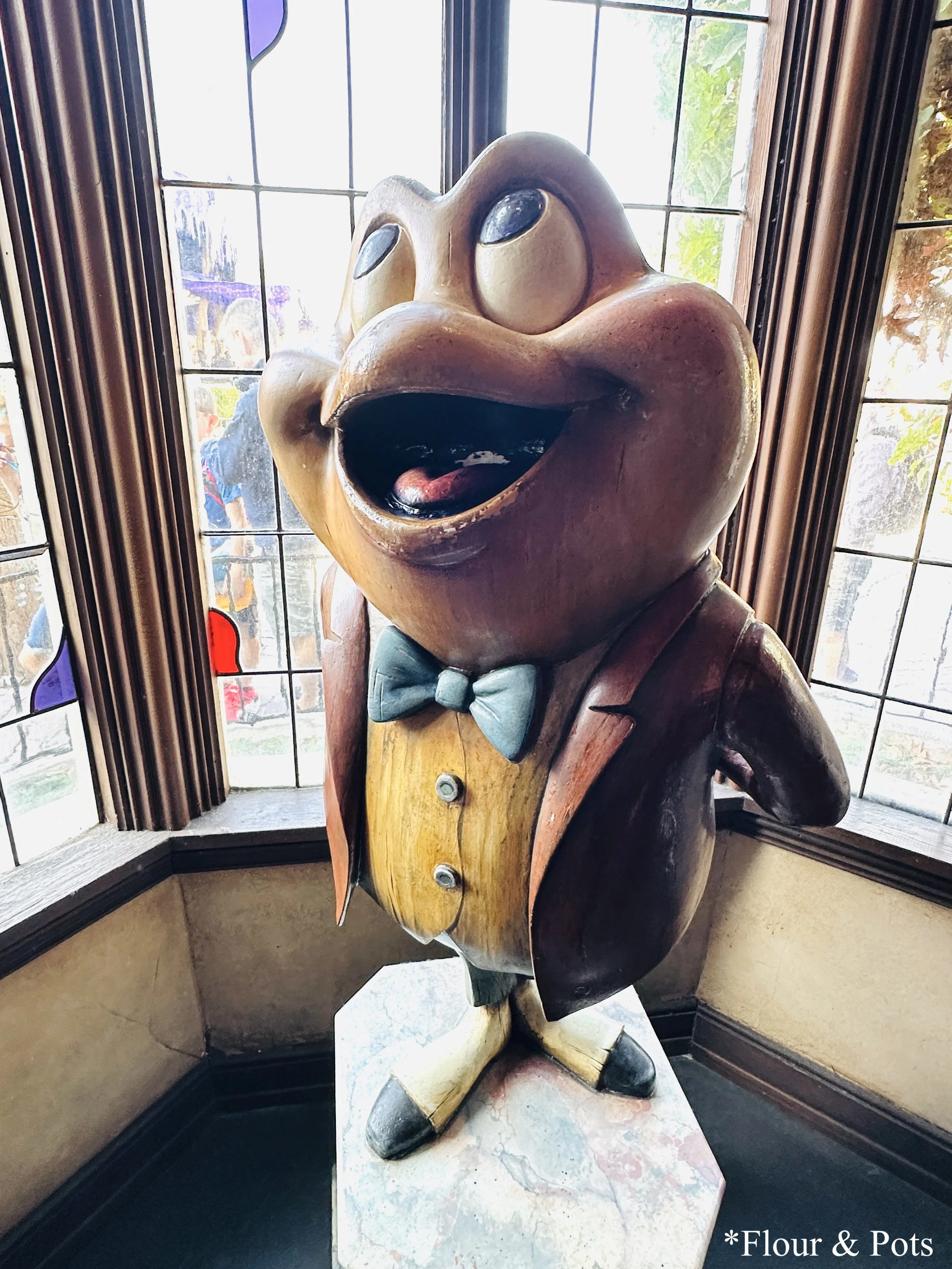Disneyland’s Toad’s Wild Ride featuring a decorative toad statue.