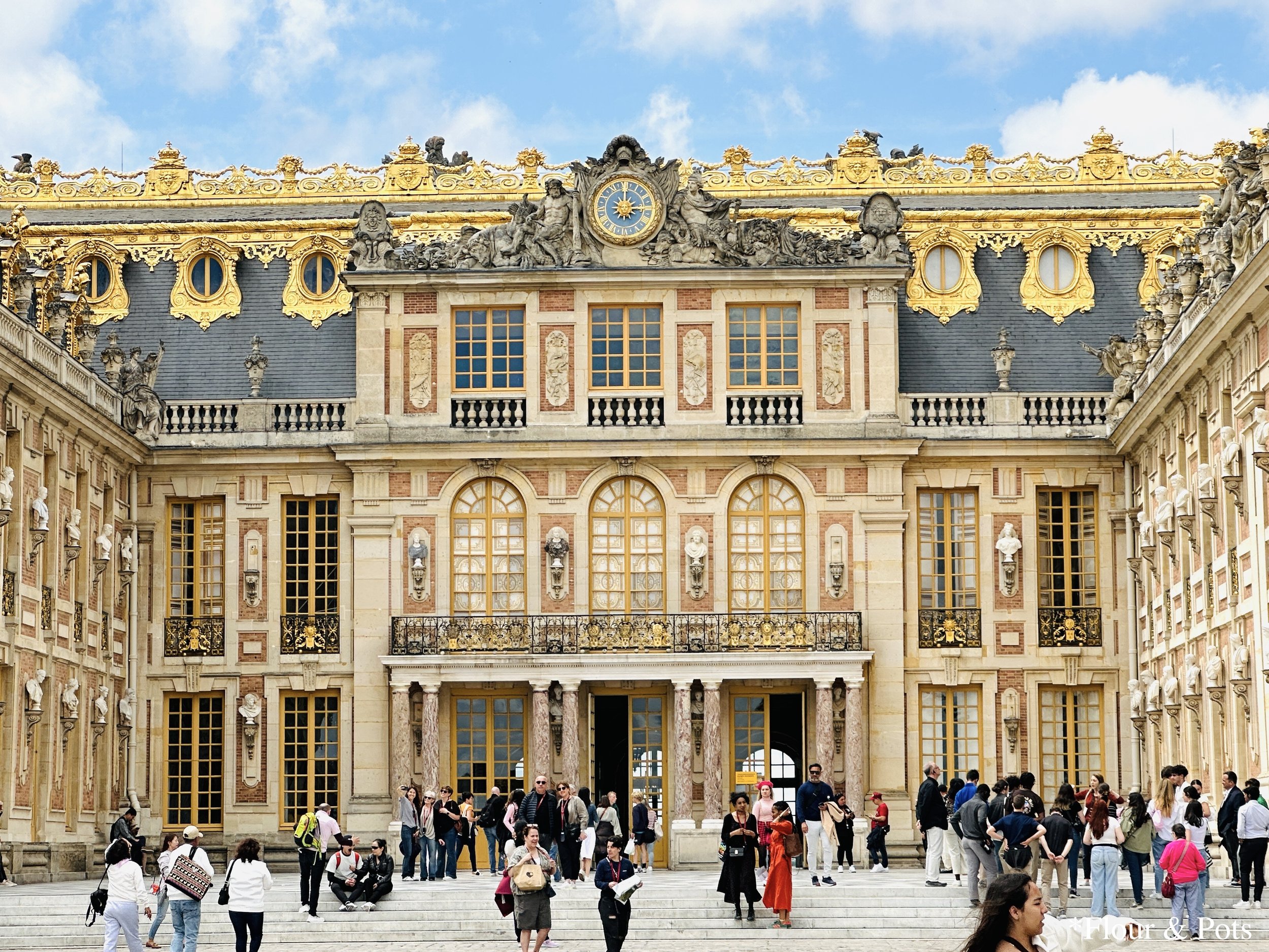 The golden and stunning main entrance of the Palace of Versailles in France.