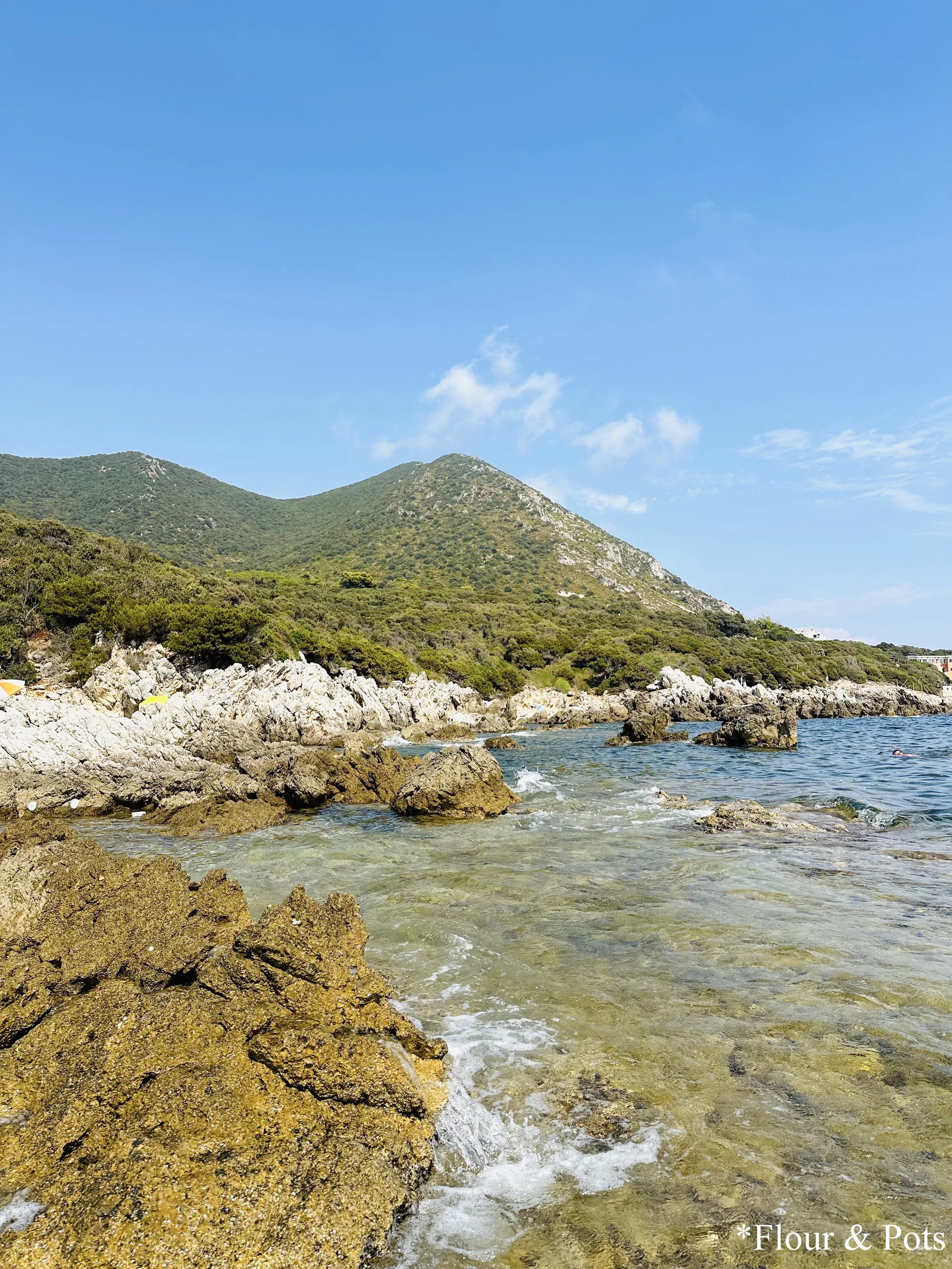 Rocky coastline of Punta Rosa, Italy, showcasing the beautiful Mediterranean sea on a day trip from Rome.