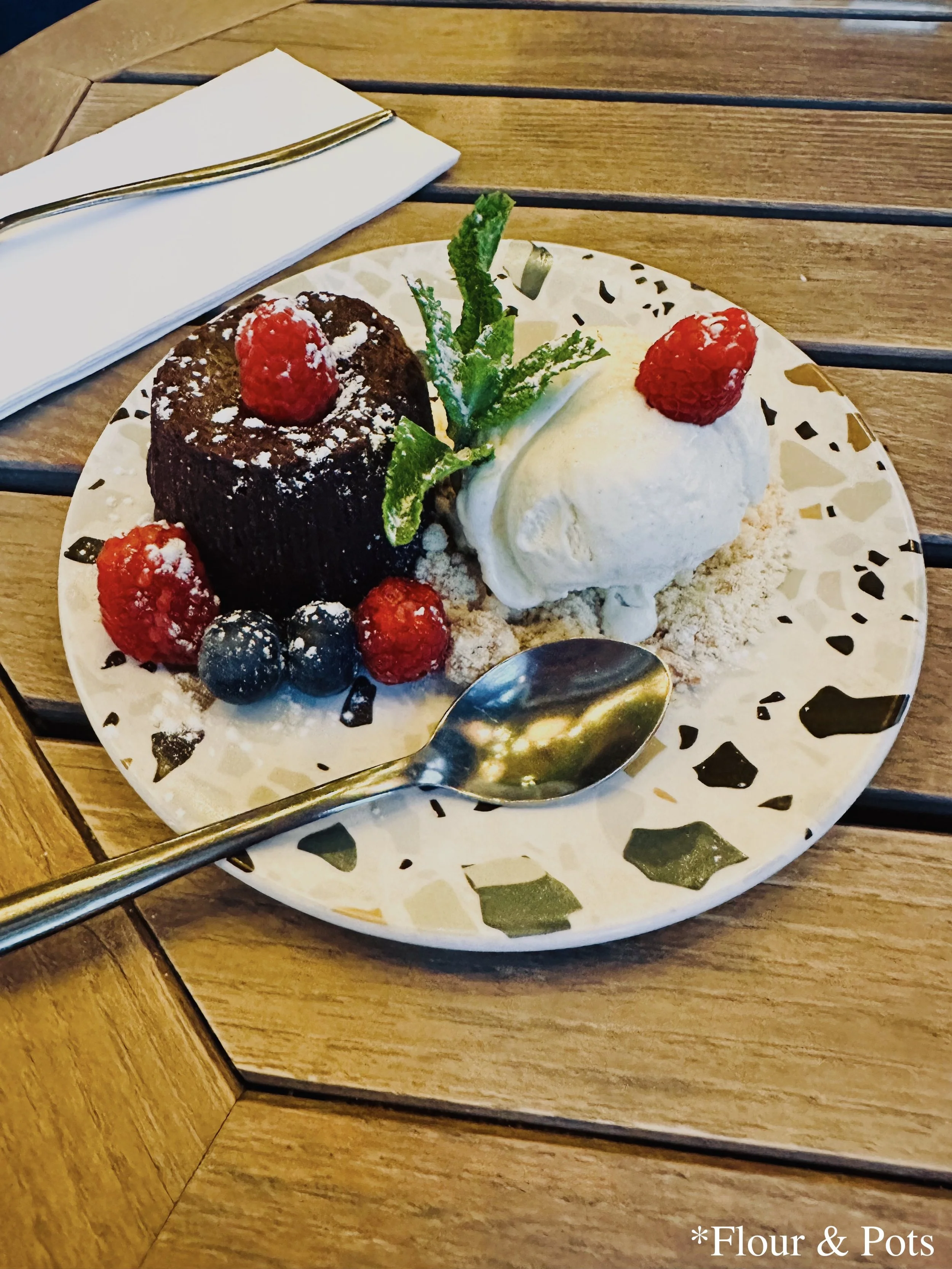 Chocolate lava-style Italian cake served with creamy vanilla gelato from Bianca restaurant in Paris, France.