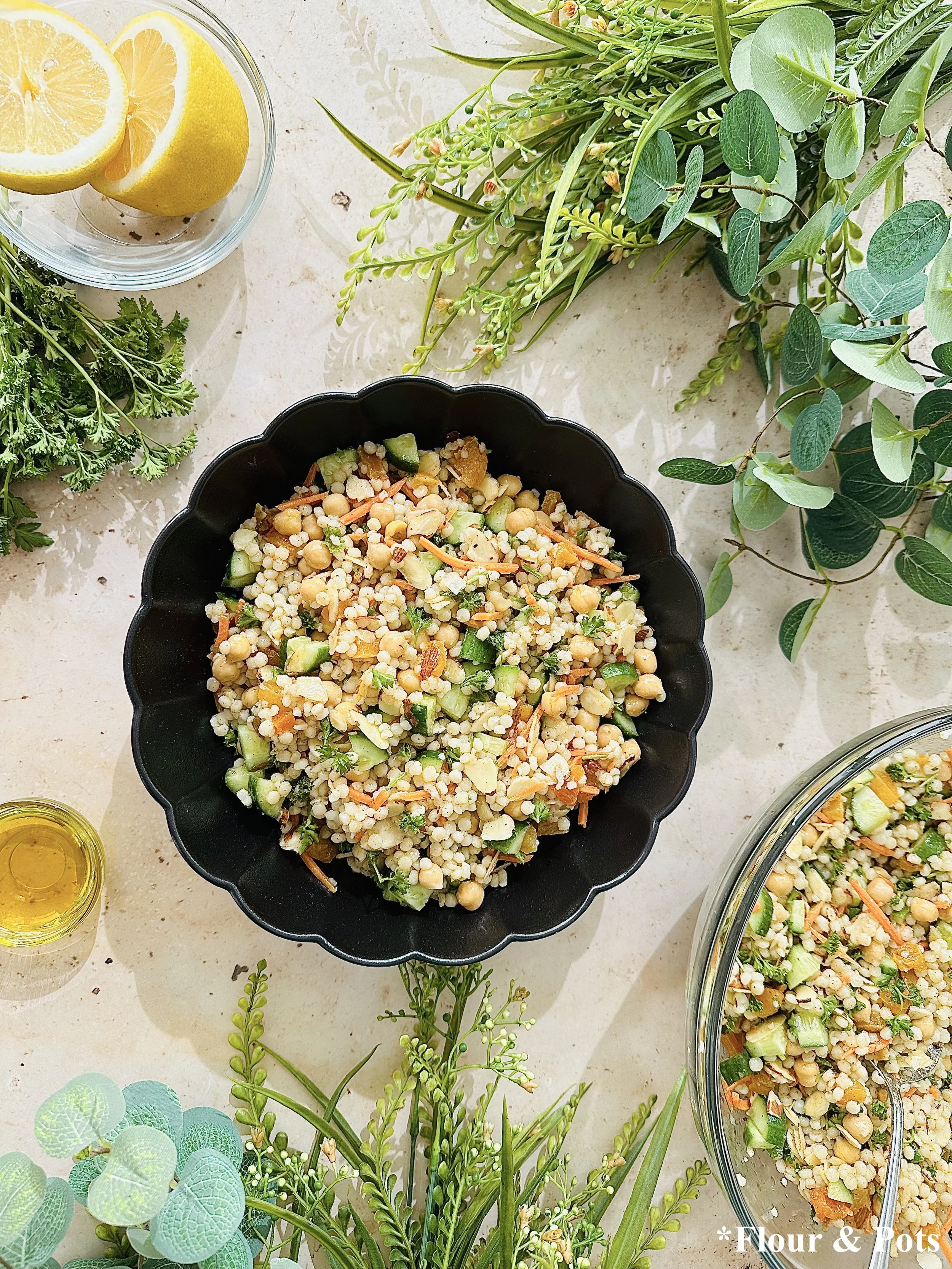 Fresh chopped parsley, diced cucumbers, and shredded carrots ready to mix into couscous salad