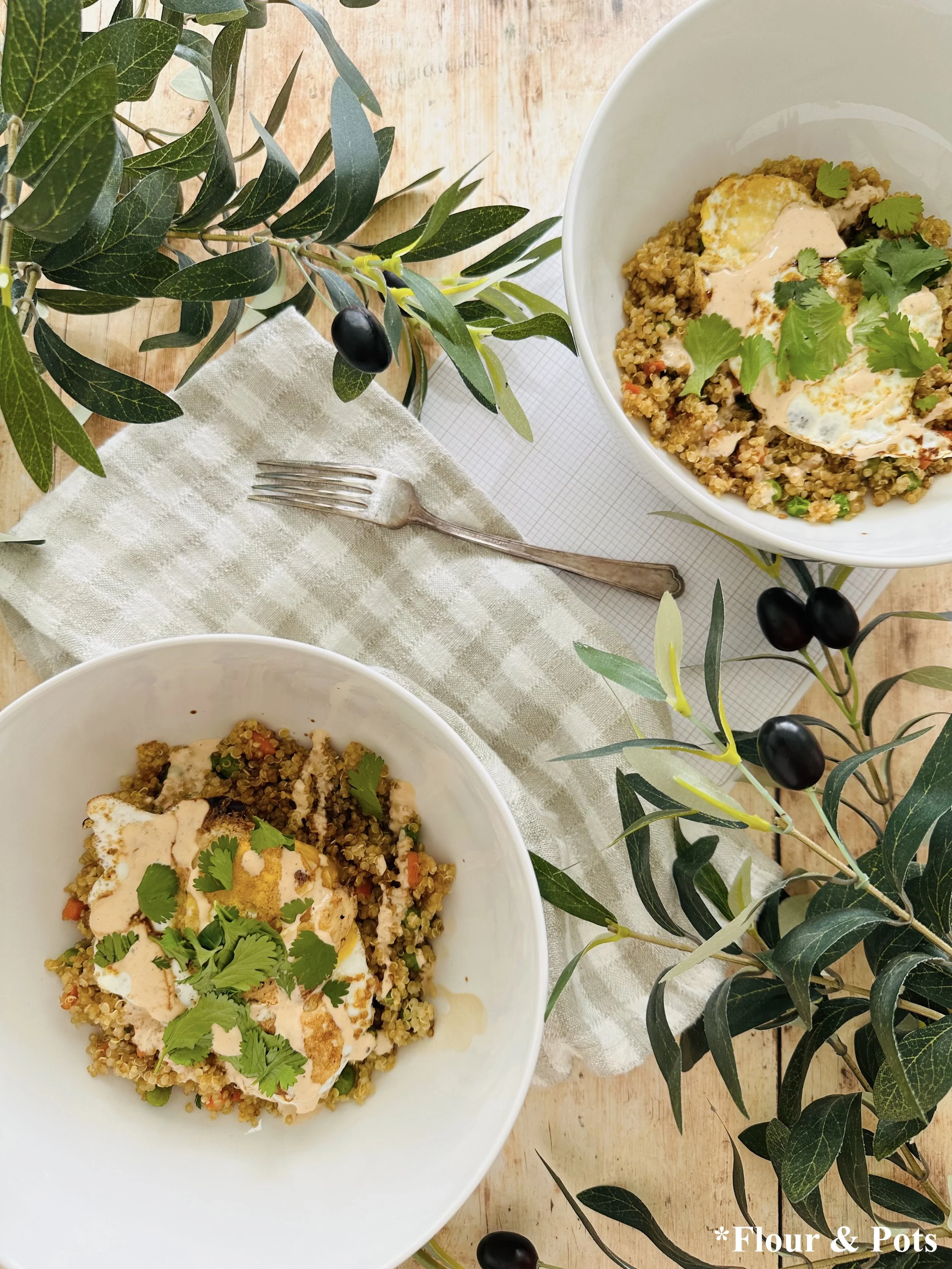 Asian-inspired quinoa breakfast bowl with veggies, egg, and spicy sweet sauce