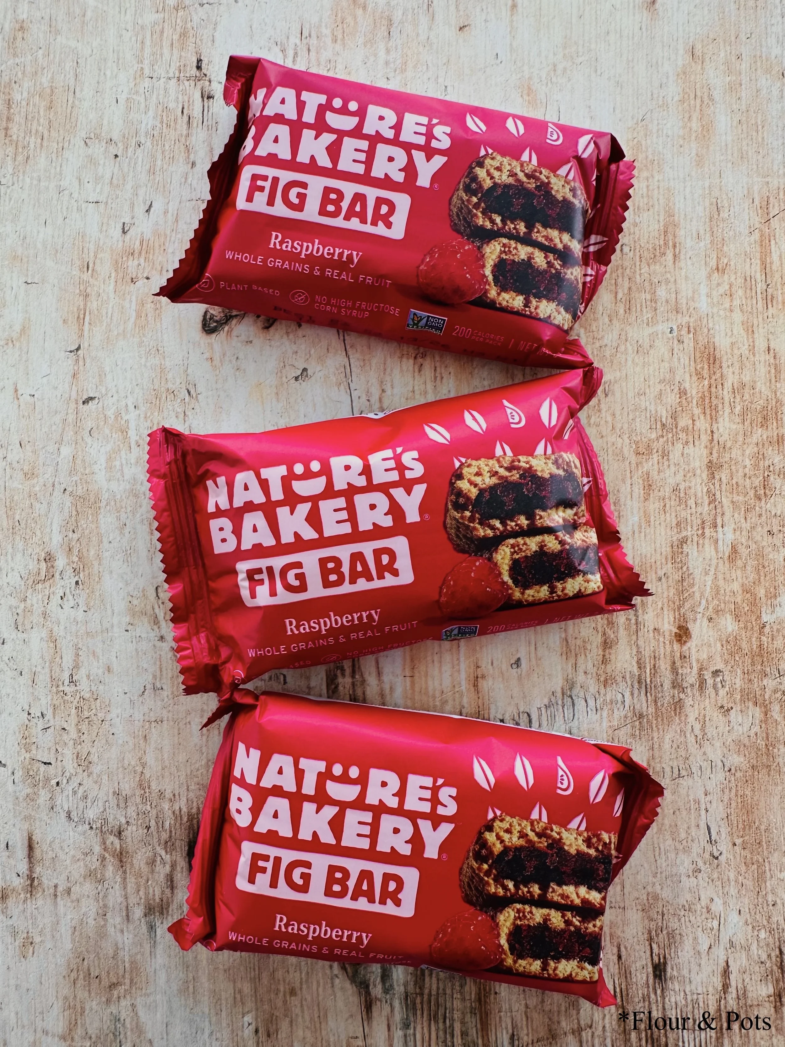 Nature's Bakery raspberry fig bar package featuring a vibrant, berry-themed design.