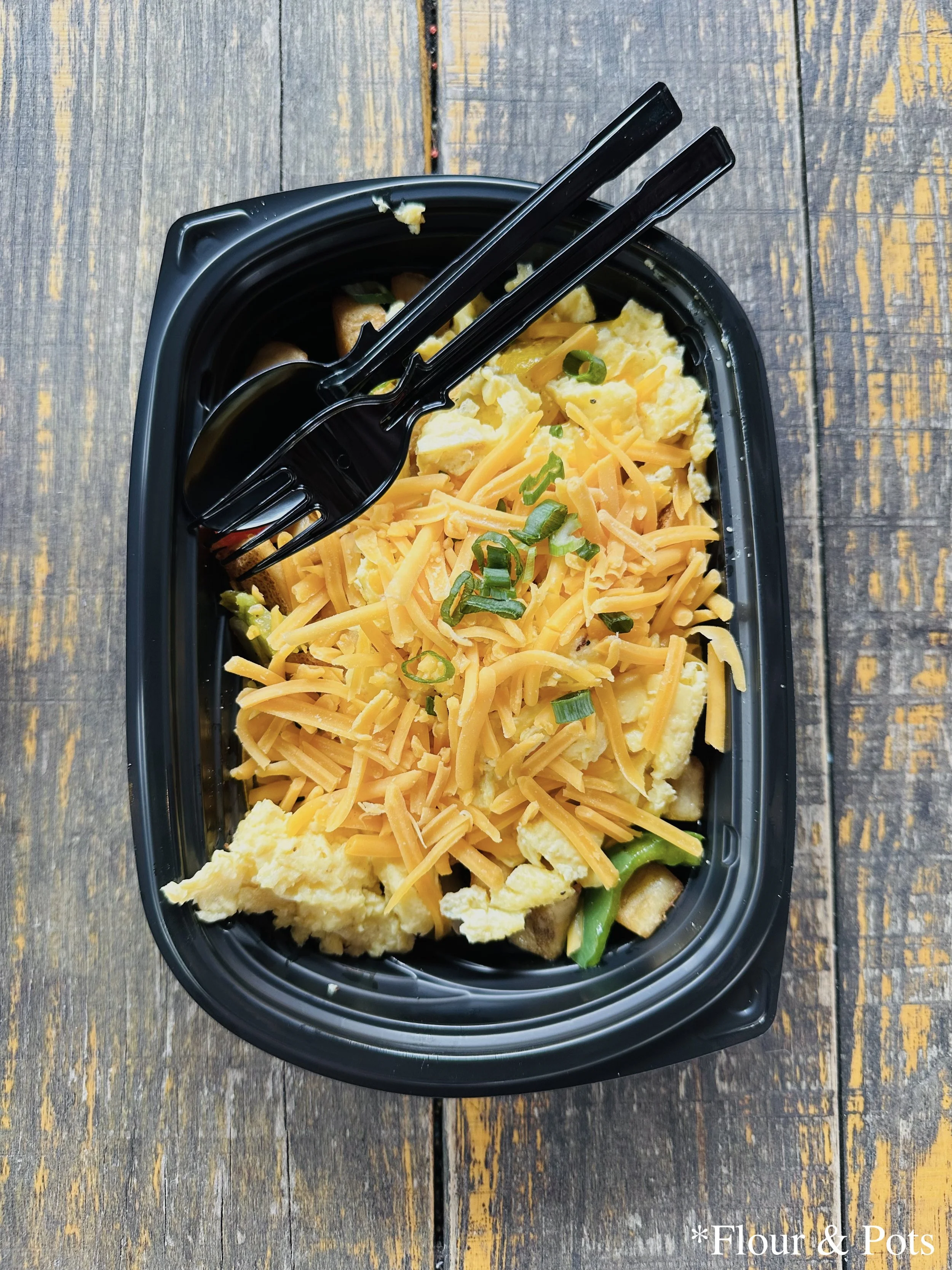 A breakfast egg bowl served at Yak & Yeti Food Café in Disney's Animal Kingdom, Orlando, Florida, featuring scrambled eggs, vegetables, and savory toppings in a vibrant and hearty morning meal.