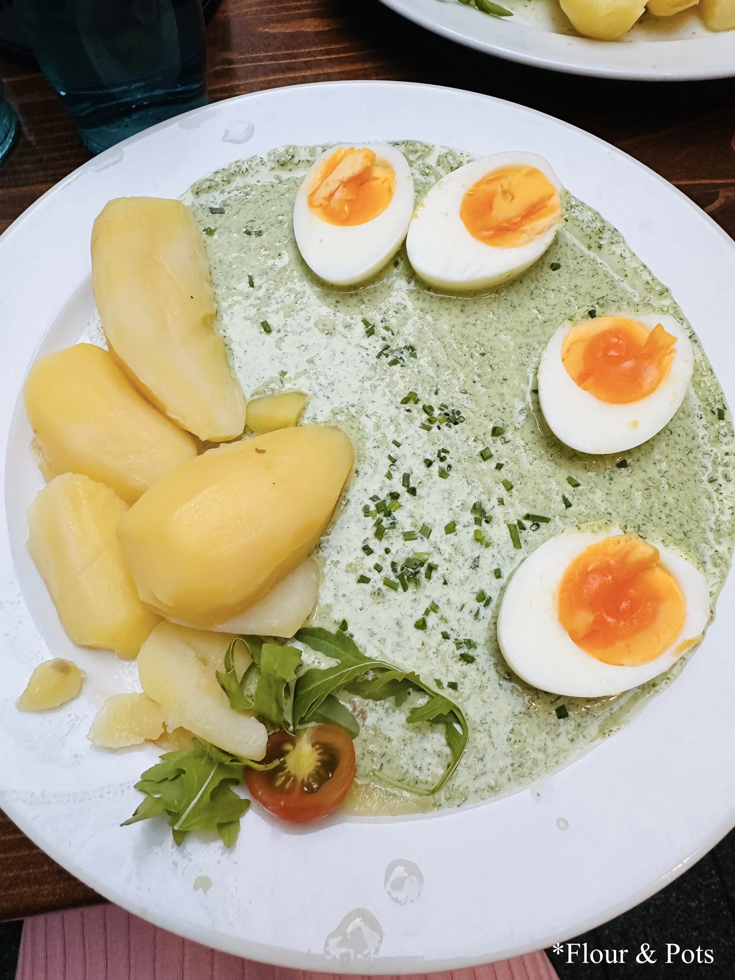 Traditional Frankfurt green sauce (Grüne Soße) made with herbs, served with boiled potatoes and hard-boiled eggs, a local culinary specialty.