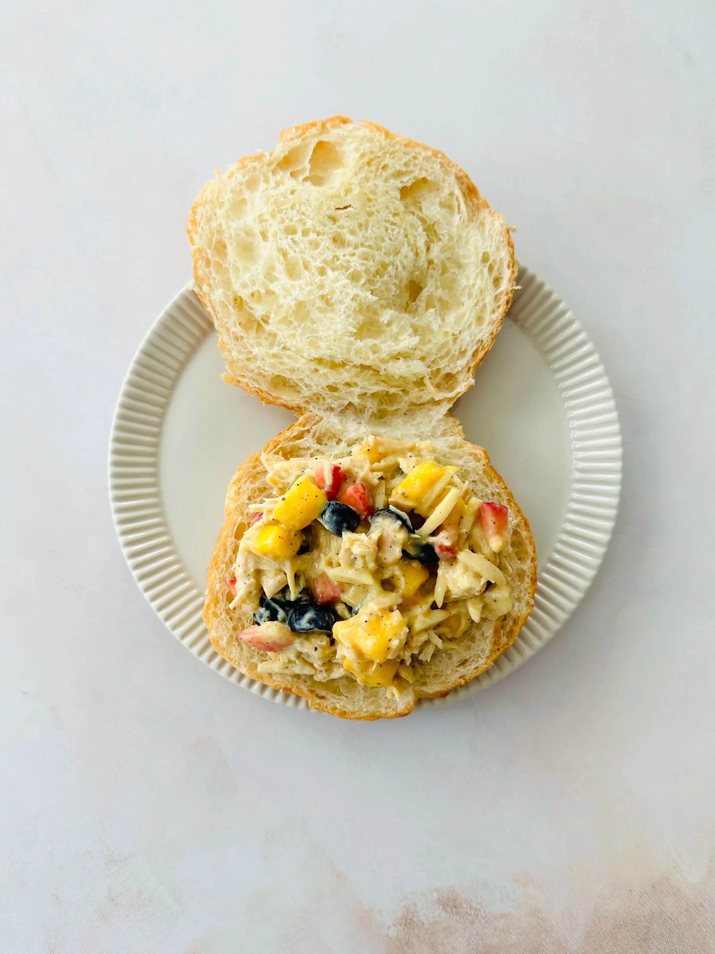 Fresh mangoberry chicken salad sandwich served on a buttery croissant