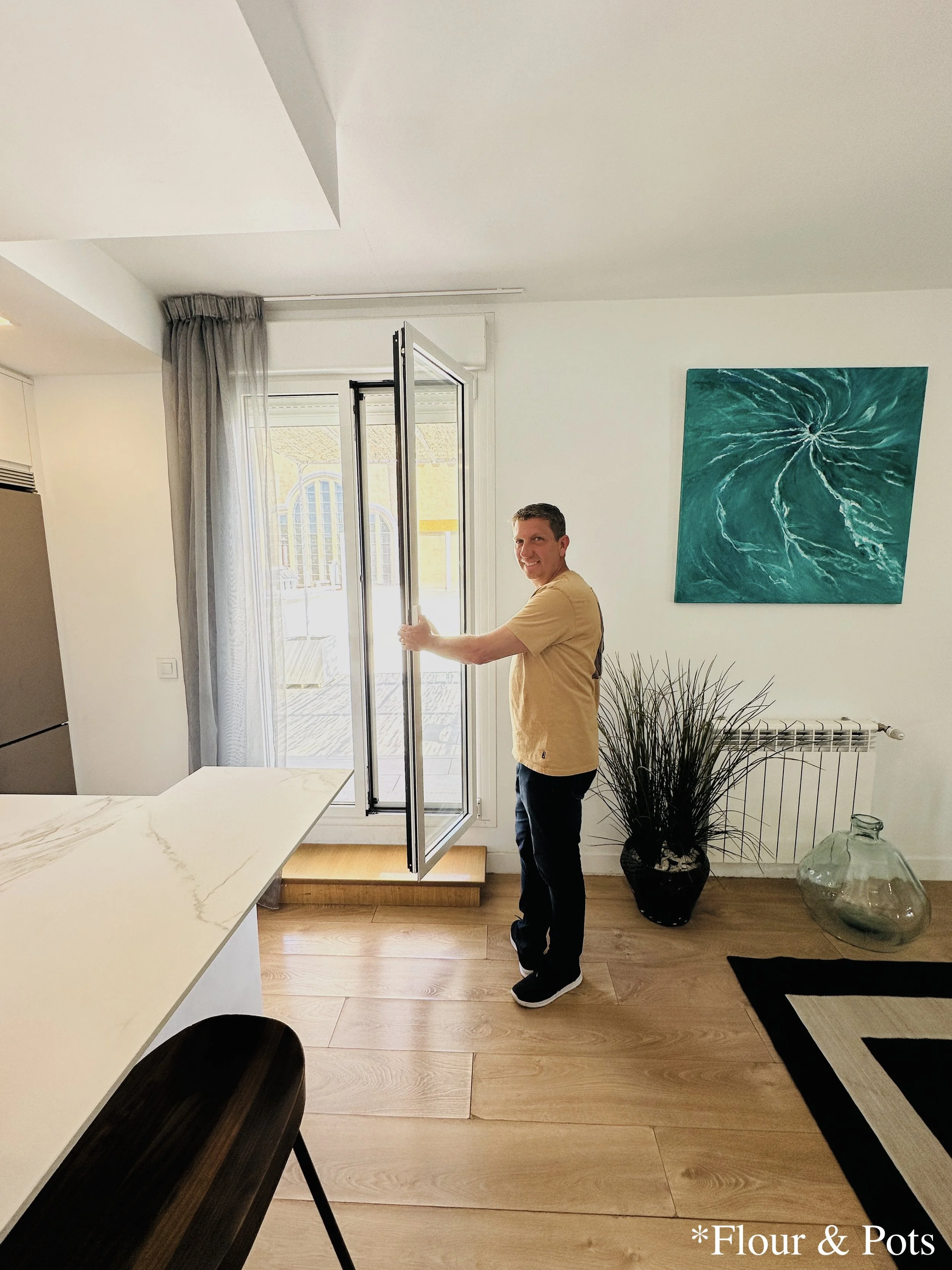 My dad opening the patio door of our Airbnb in Madrid, Spain, leading out to the cozy outdoor space.