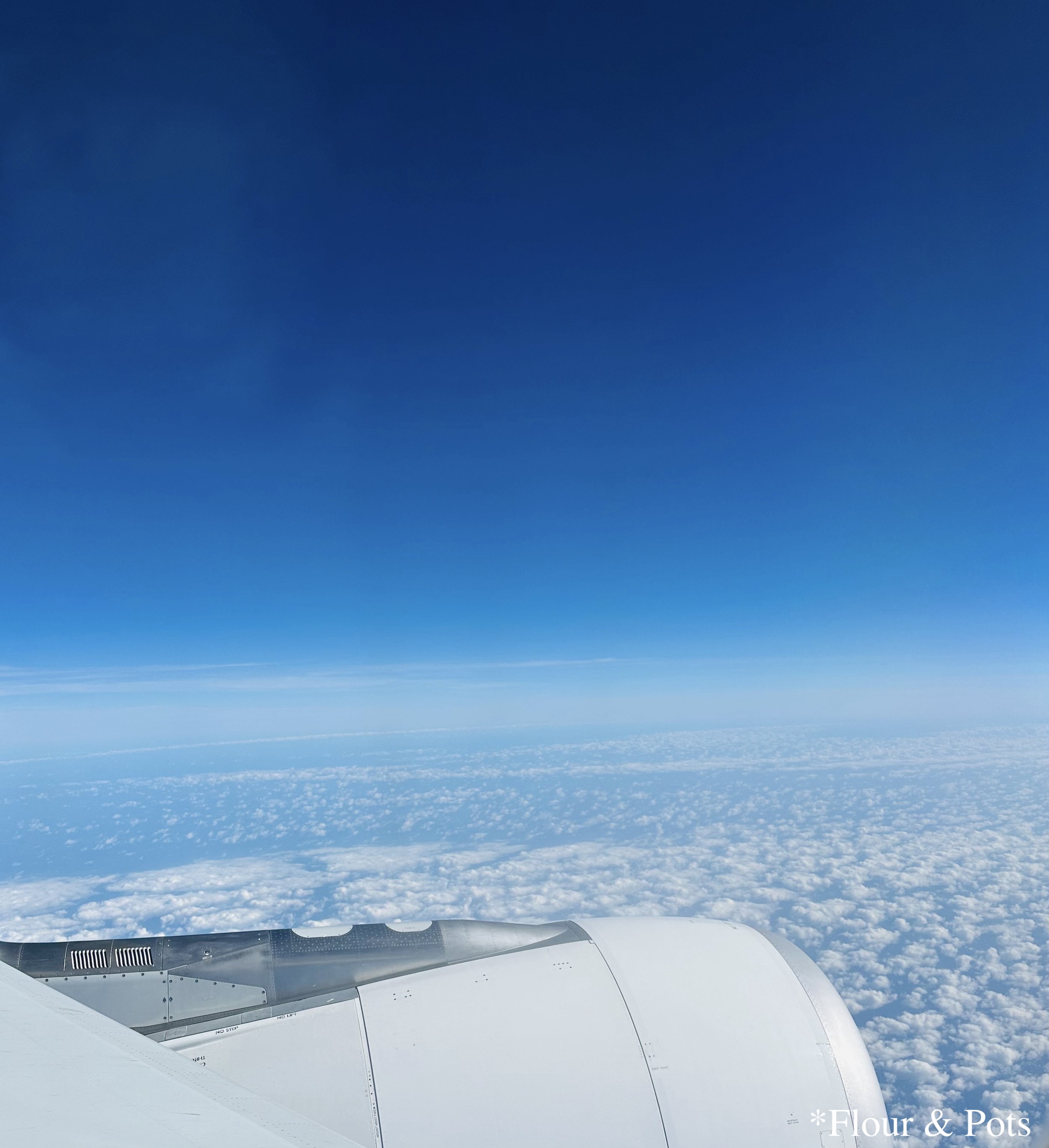 A view from the window of a flight between Madrid (MAD) and Dallas/Fort Worth (DFW), captured in the middle of the day.