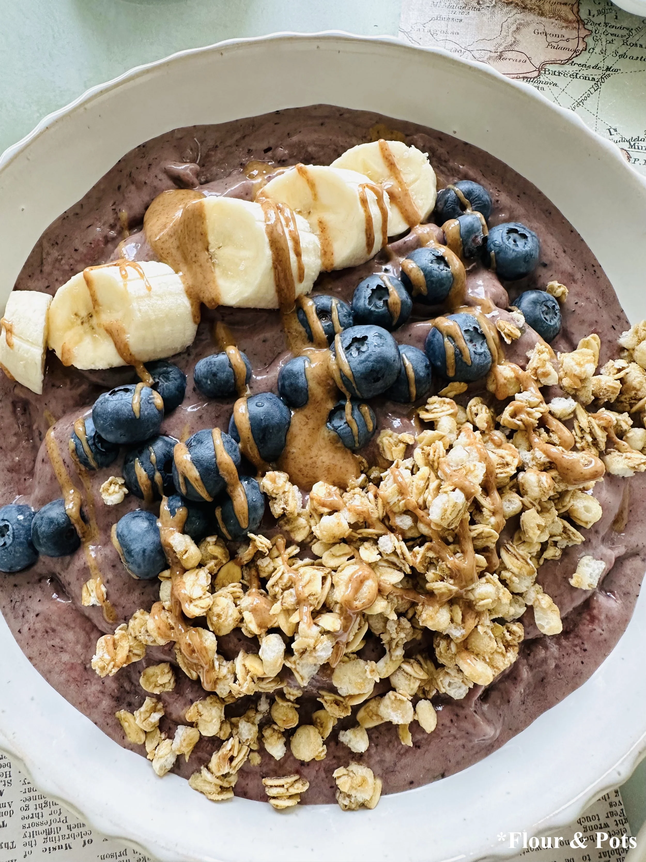 Close-up of Fruit and Granola Topped Berry Green Smoothie Bowls