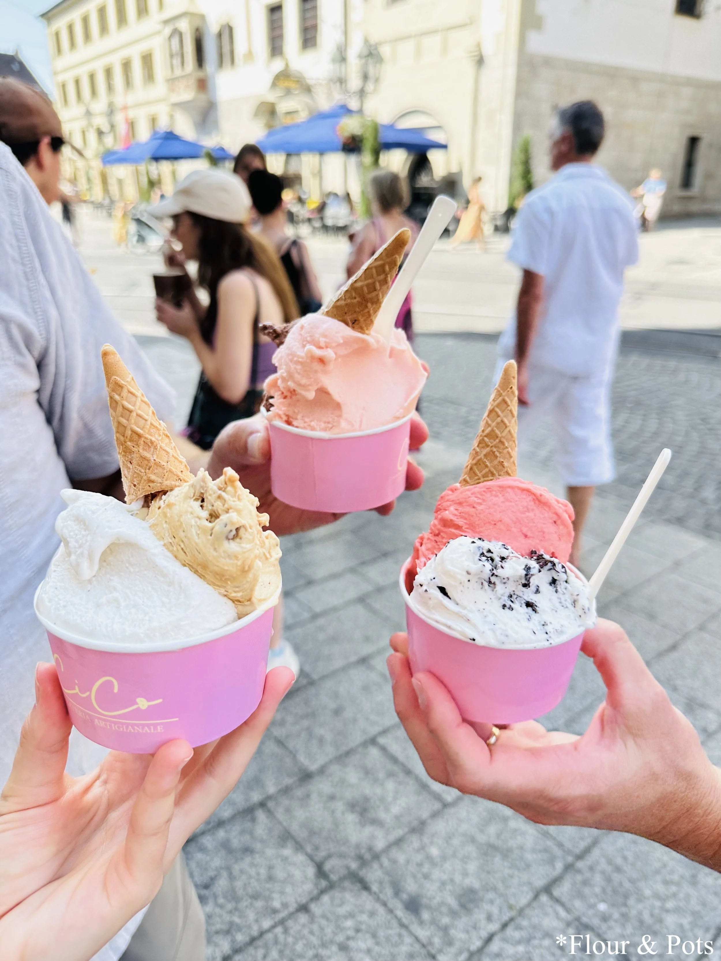 Enjoying a cup of gelato from Cico Gelateria Artigianale in Würzburg, Germany, near the Vierroehrenbrunnen fountain.