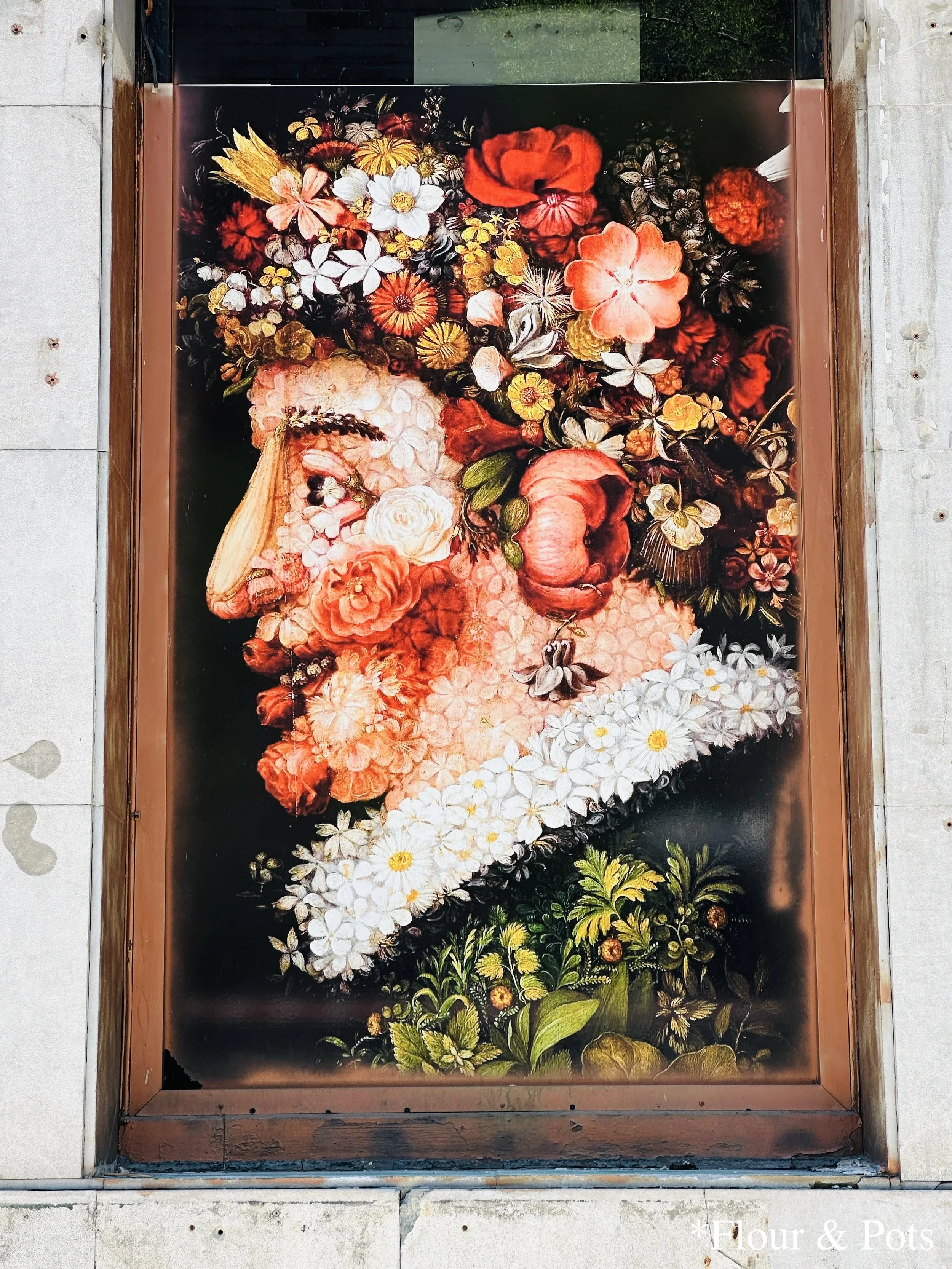 Street art in Madrid, Spain, depicting a Spanish man surrounded by colorful flowers, painted on a wall in the city's vibrant streets.