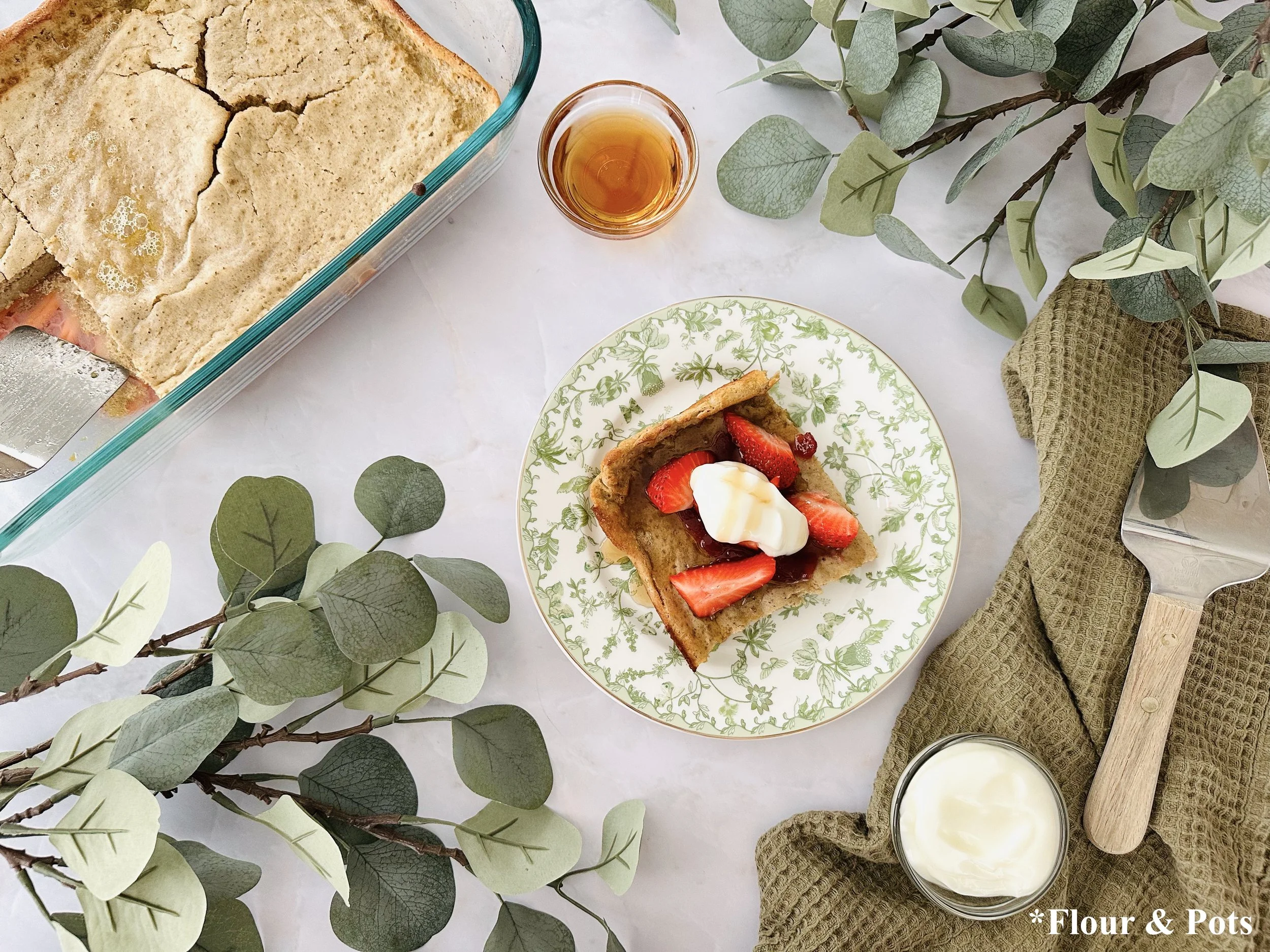 Lightly sweet strawberry Dutch baby pancake with vanilla and lemon