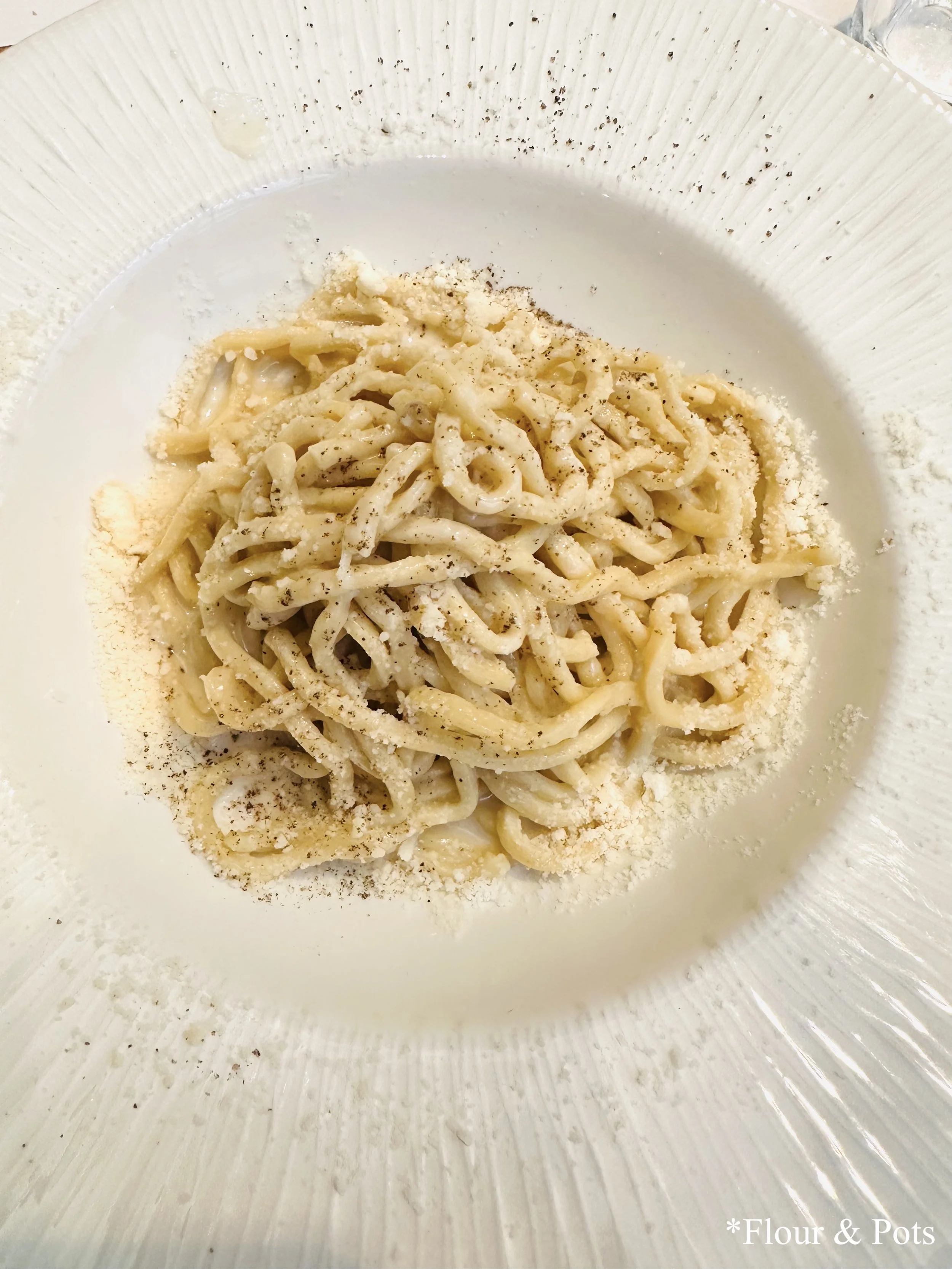 Plate of Cacio e Pepe pasta, a classic Roman dish, served in Rome, Italy.